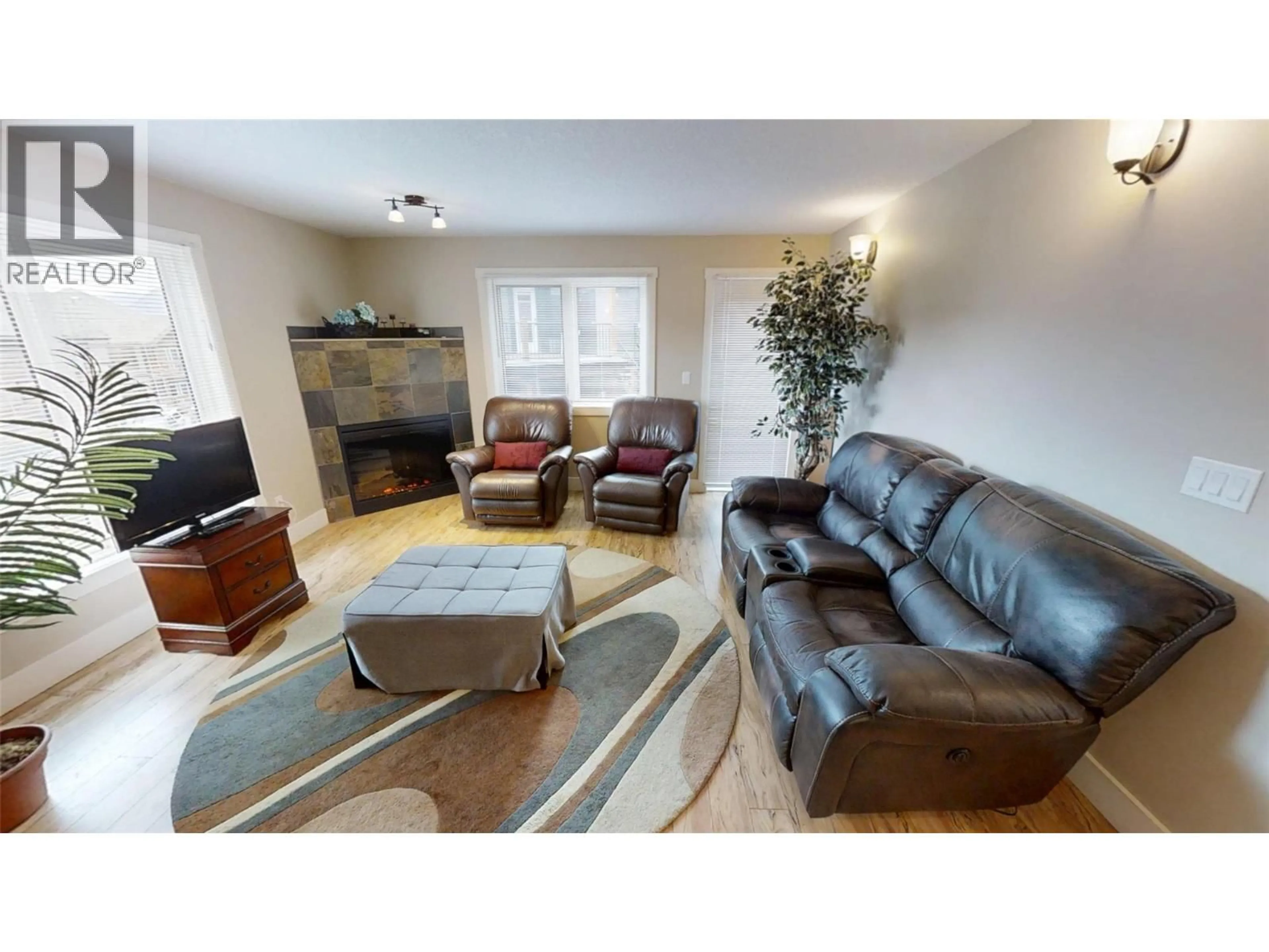 Living room with furniture, wood/laminate floor for 204 - 7337 PROSPECTOR AVENUE, Radium Hot Springs British Columbia V0A1M0