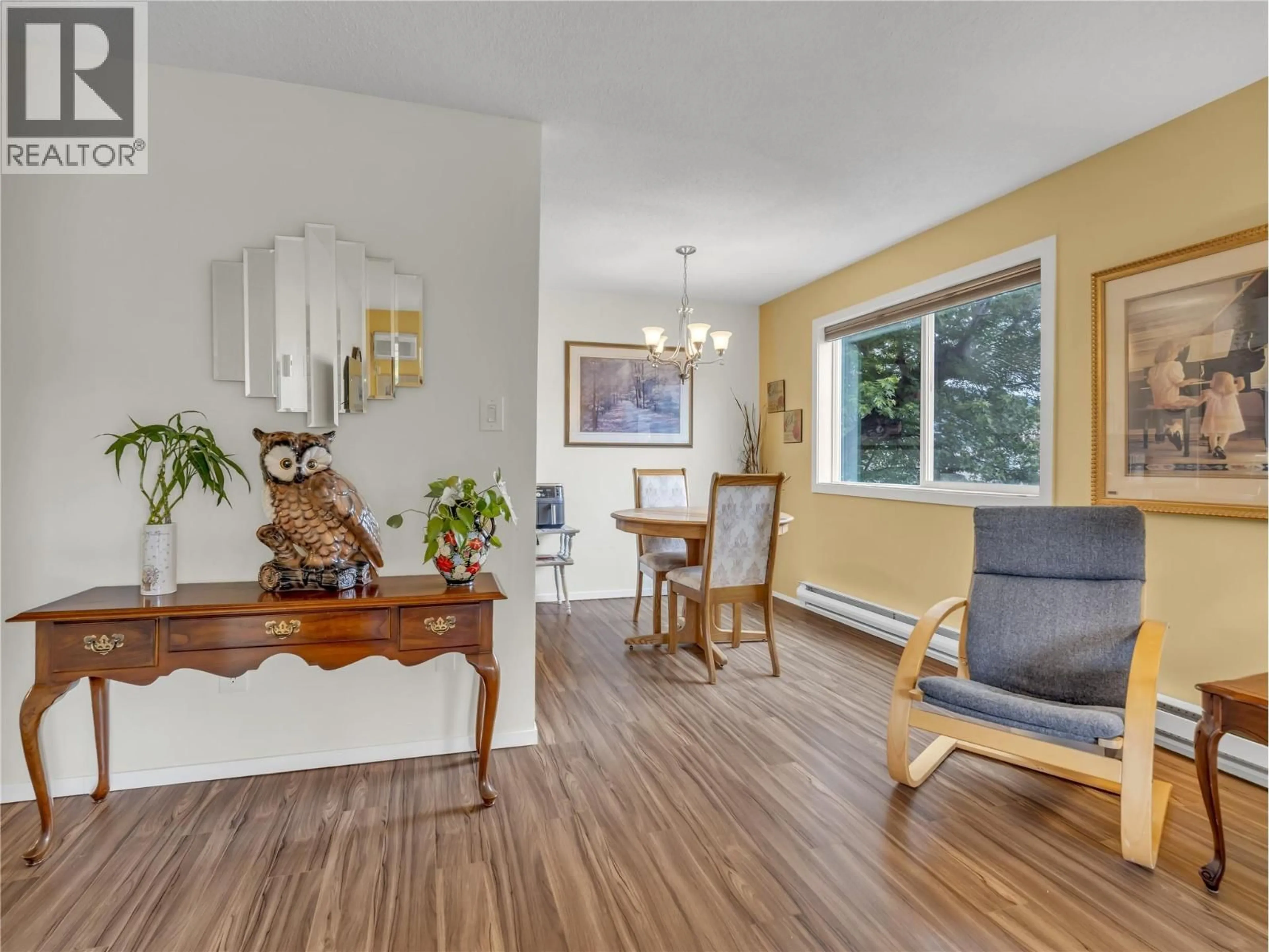 Living room with furniture, wood/laminate floor for 212 - 803 FAIRVIEW ROAD, Penticton British Columbia V2A5Y7