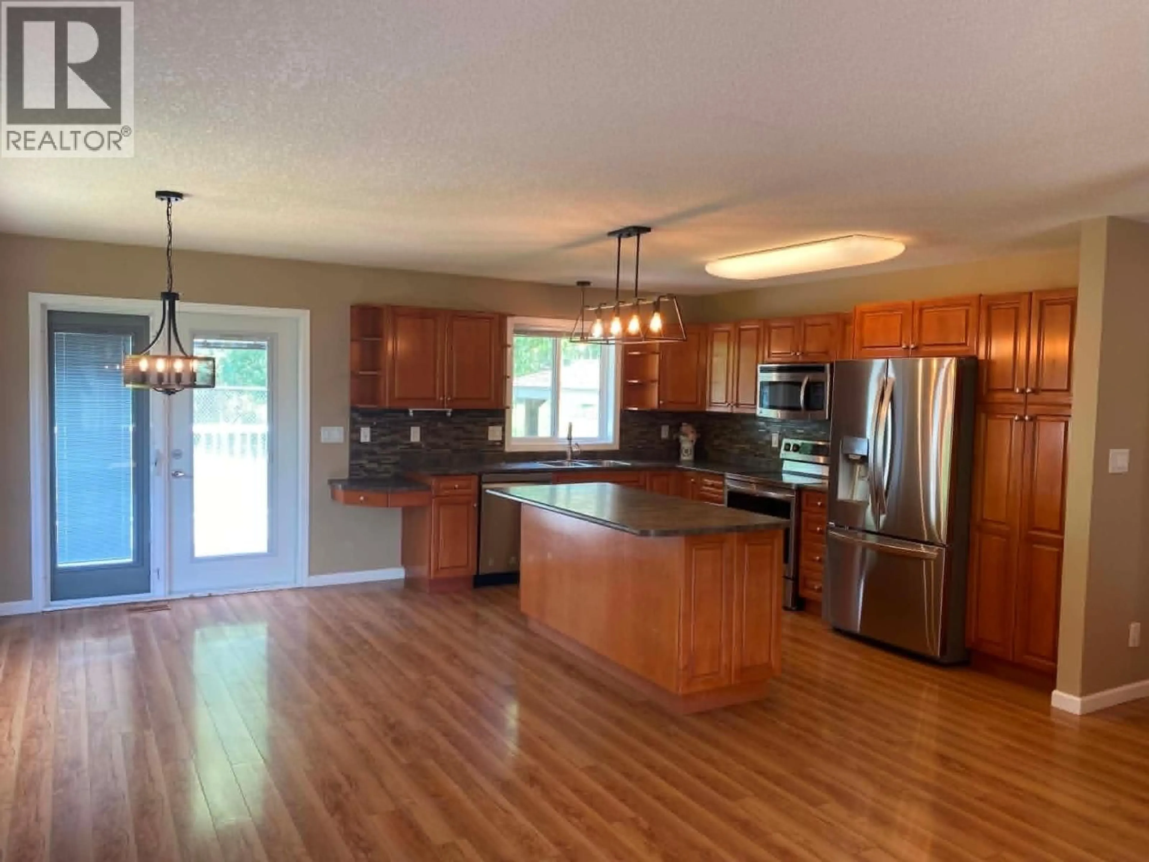 Open concept kitchen, wood/laminate floor for 5404 HILLSIDE AVENUE, Chetwynd British Columbia V0C1J0