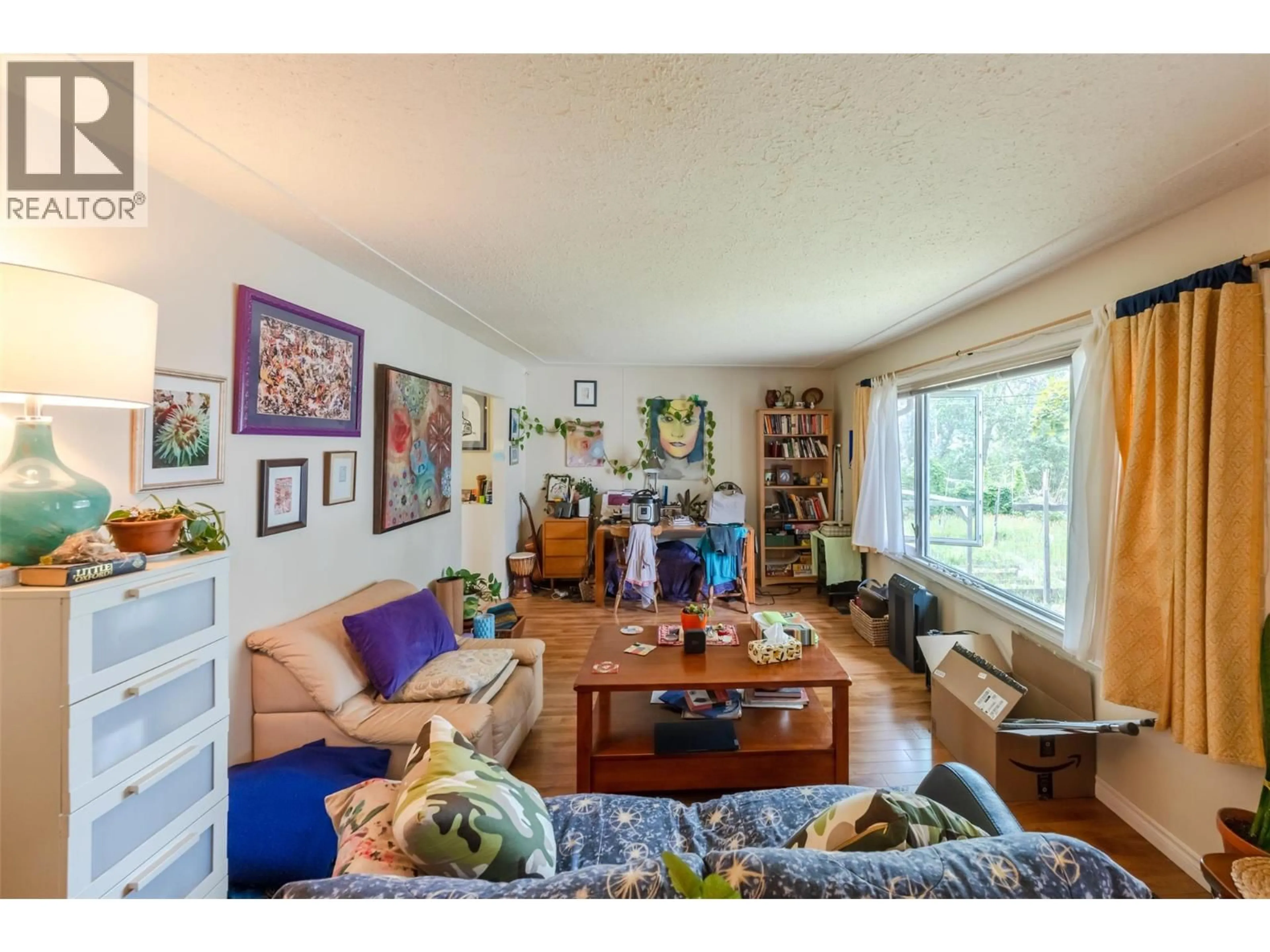 Living room with furniture, wood/laminate floor for 950 HULL STREET, Penticton British Columbia V2A4A3