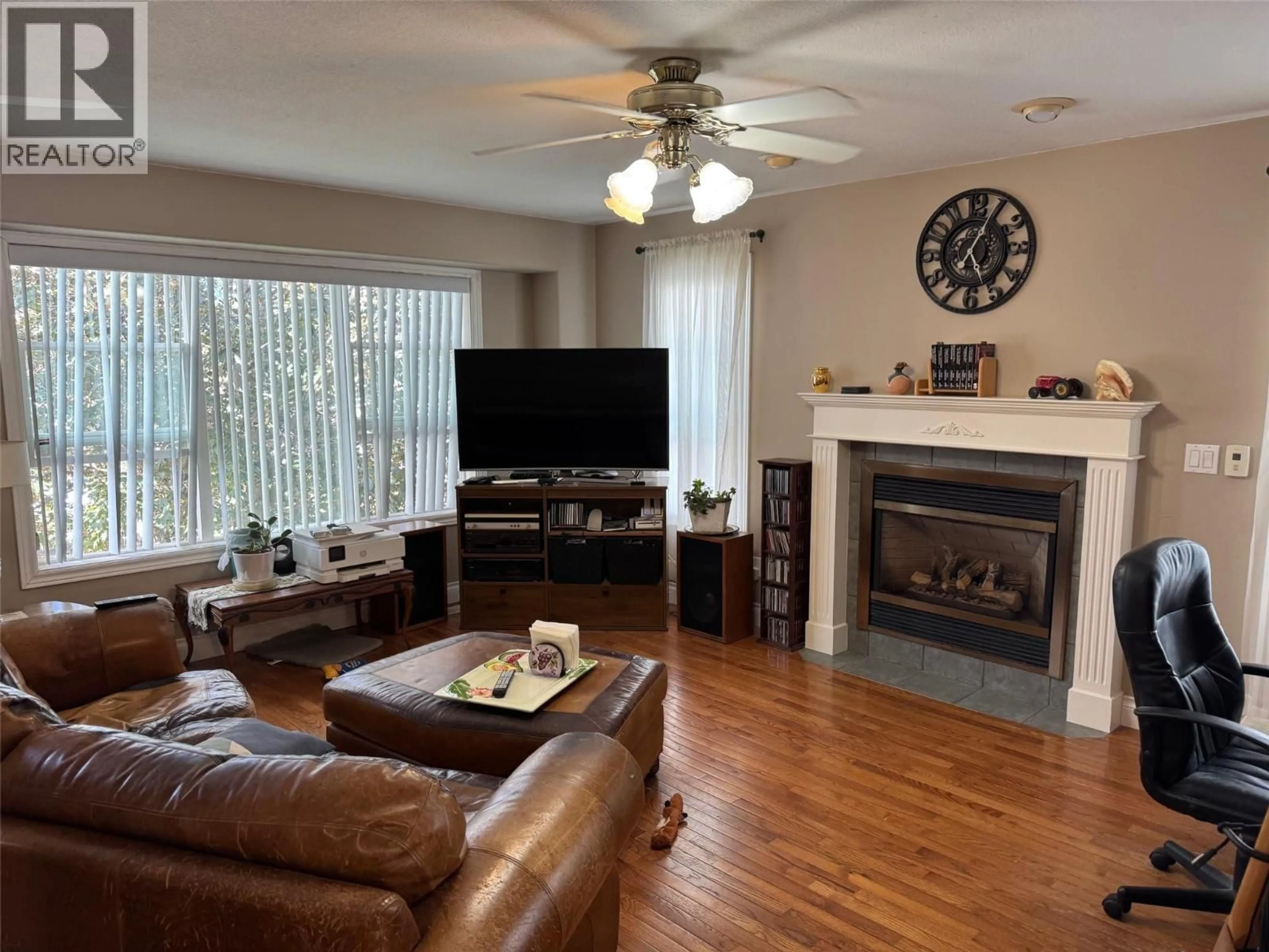 Living room with furniture, wood/laminate floor for 1313 SPRUCE AVENUE, Merritt British Columbia V1K1L2