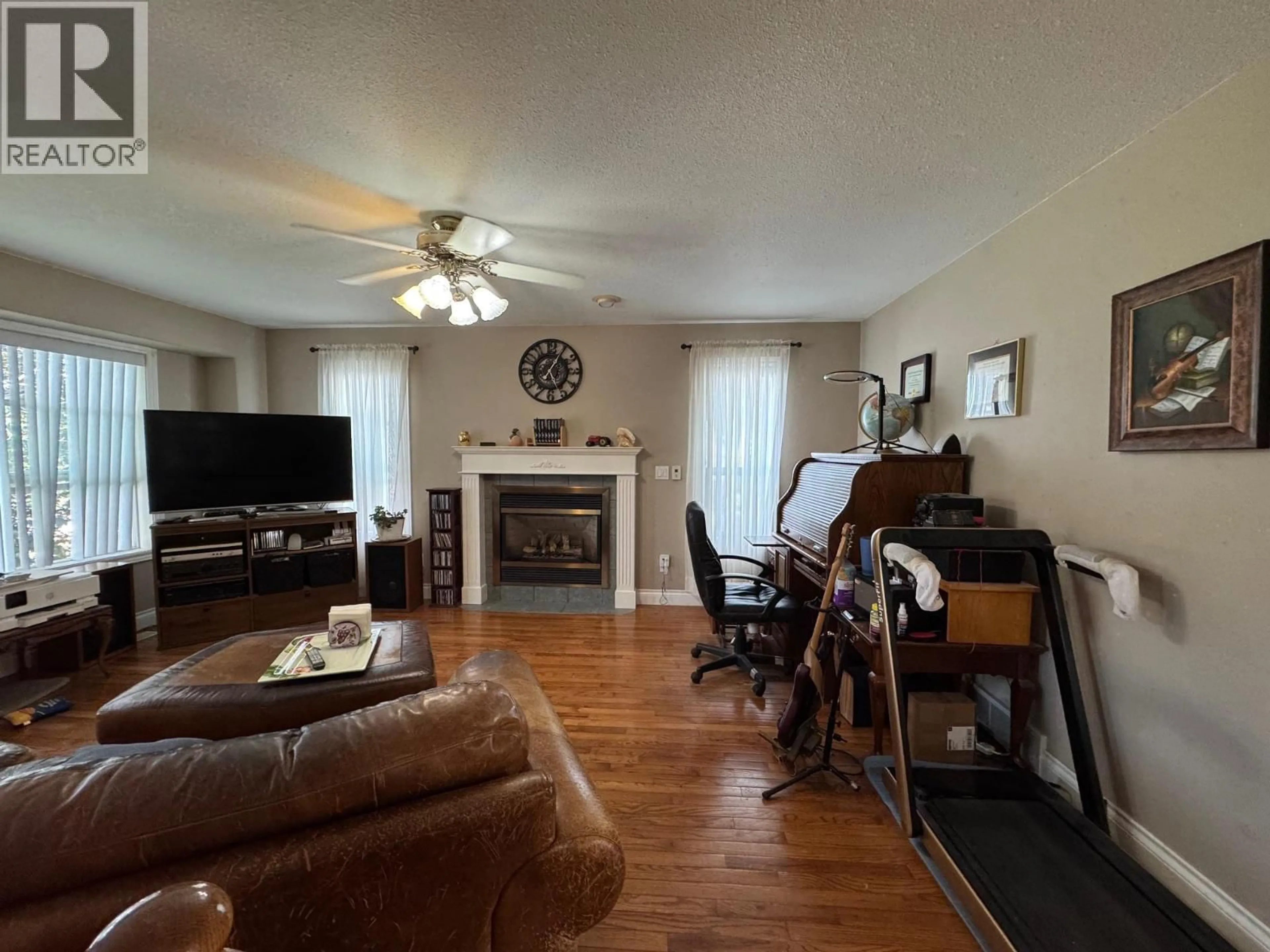 Living room with furniture, wood/laminate floor for 1313 SPRUCE AVENUE, Merritt British Columbia V1K1L2
