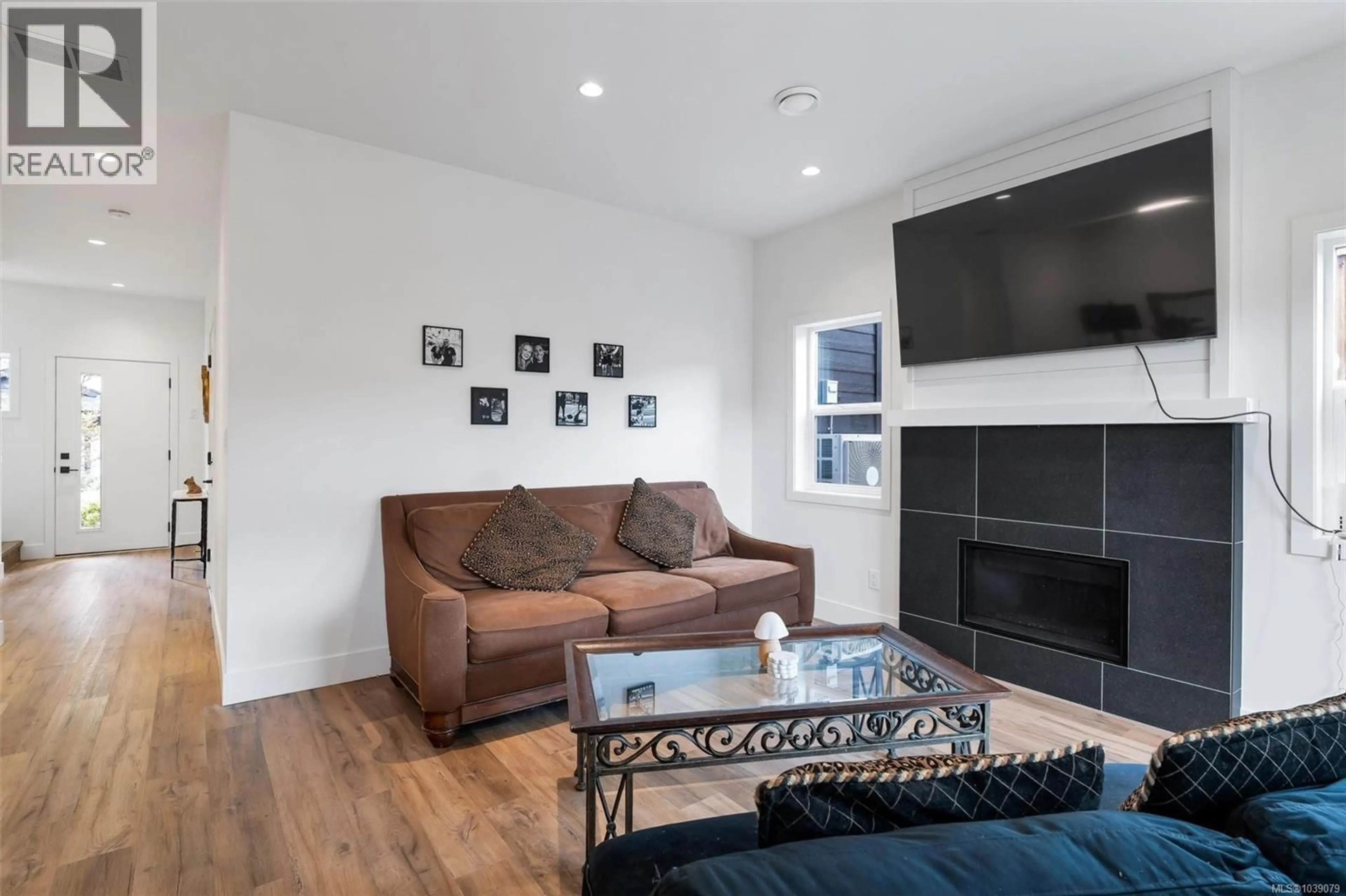 Living room with furniture, wood/laminate floor for 104 - 2379 LUND ROAD, View Royal British Columbia V9B0S9