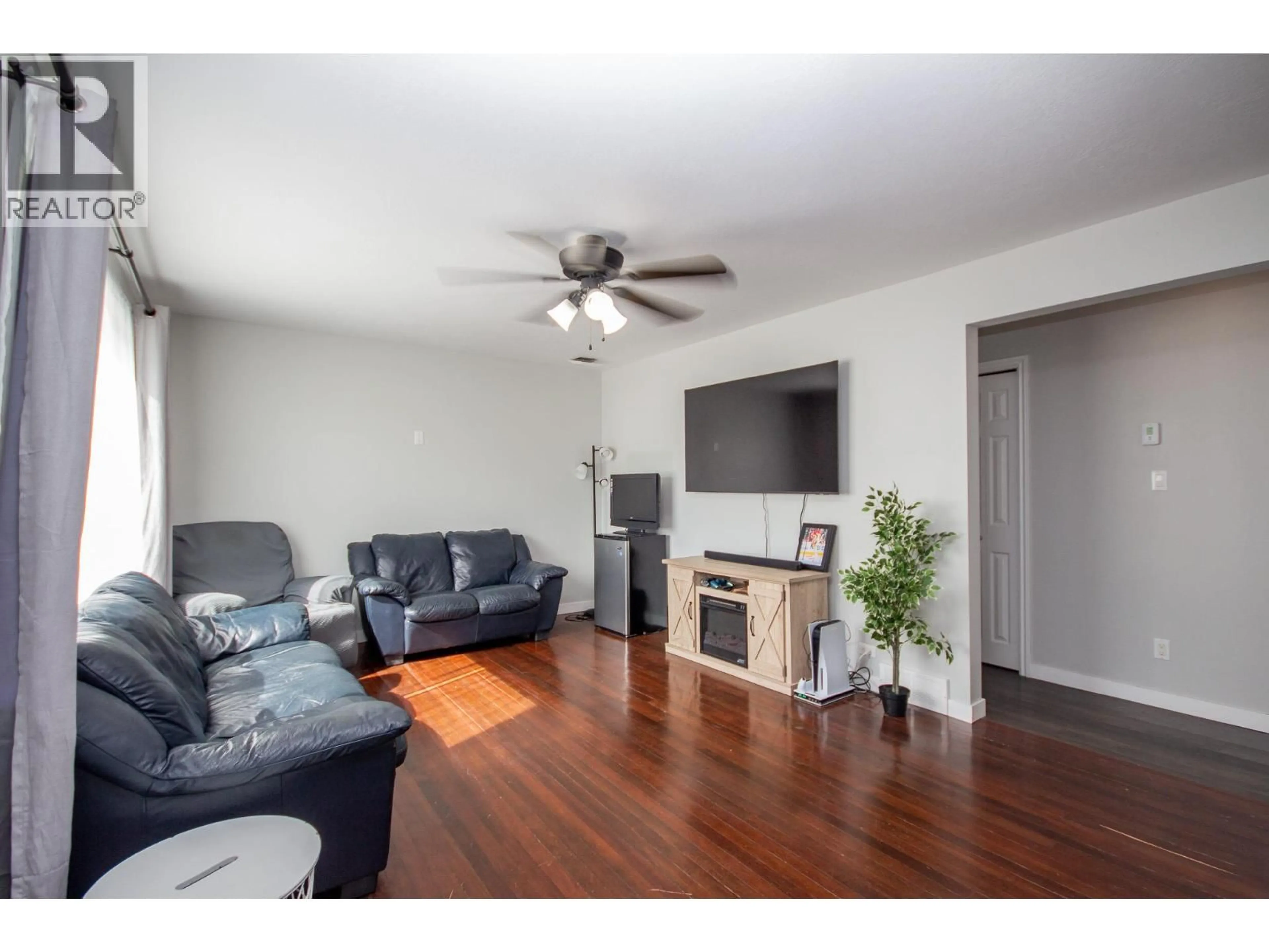 Living room with furniture, wood/laminate floor for 9116 8 STREET, Dawson Creek British Columbia V1G3N4
