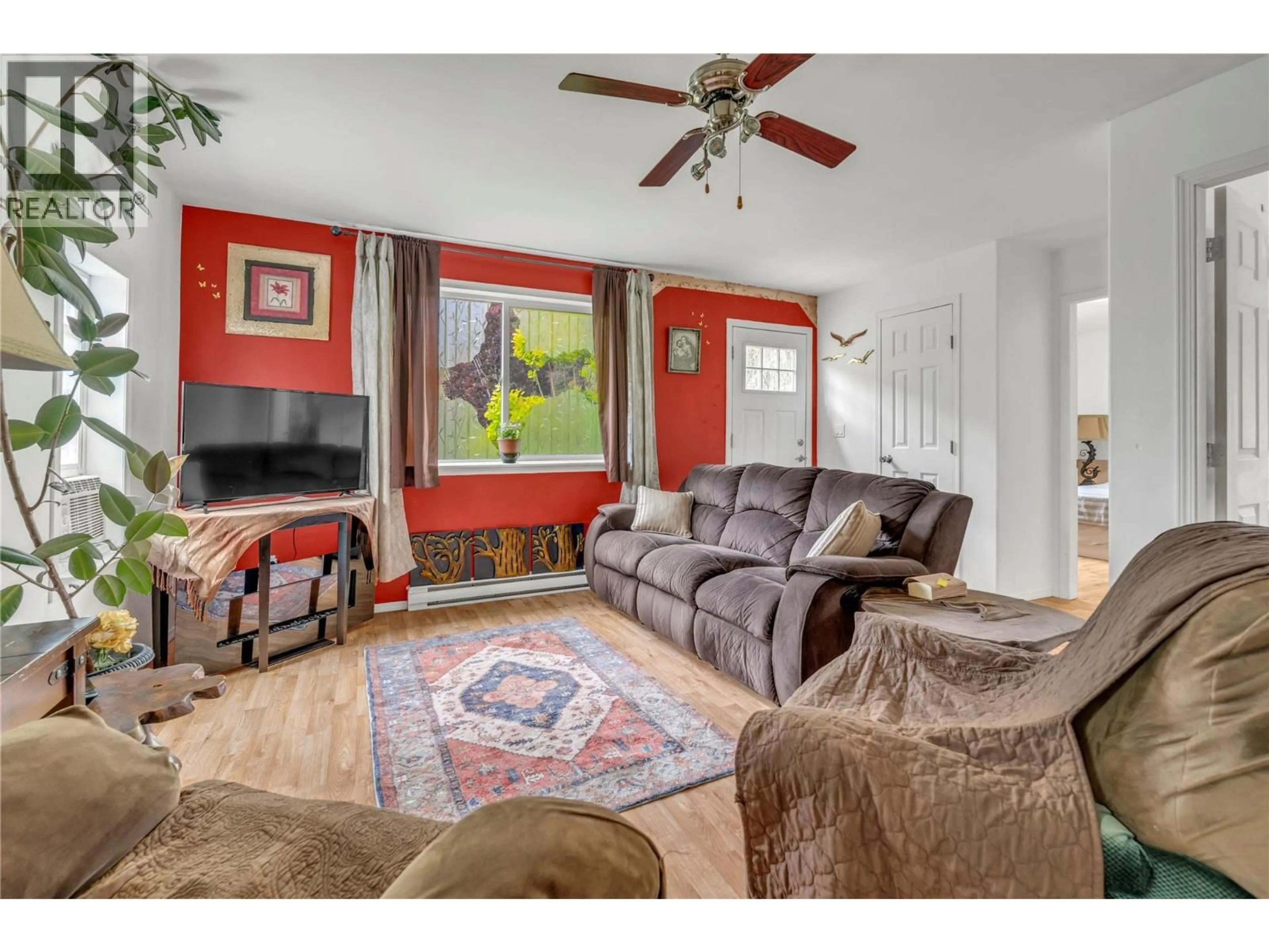 Living room with furniture, wood/laminate floor for 1530 MAIN STREET NORTH, Olalla British Columbia V0X1N6