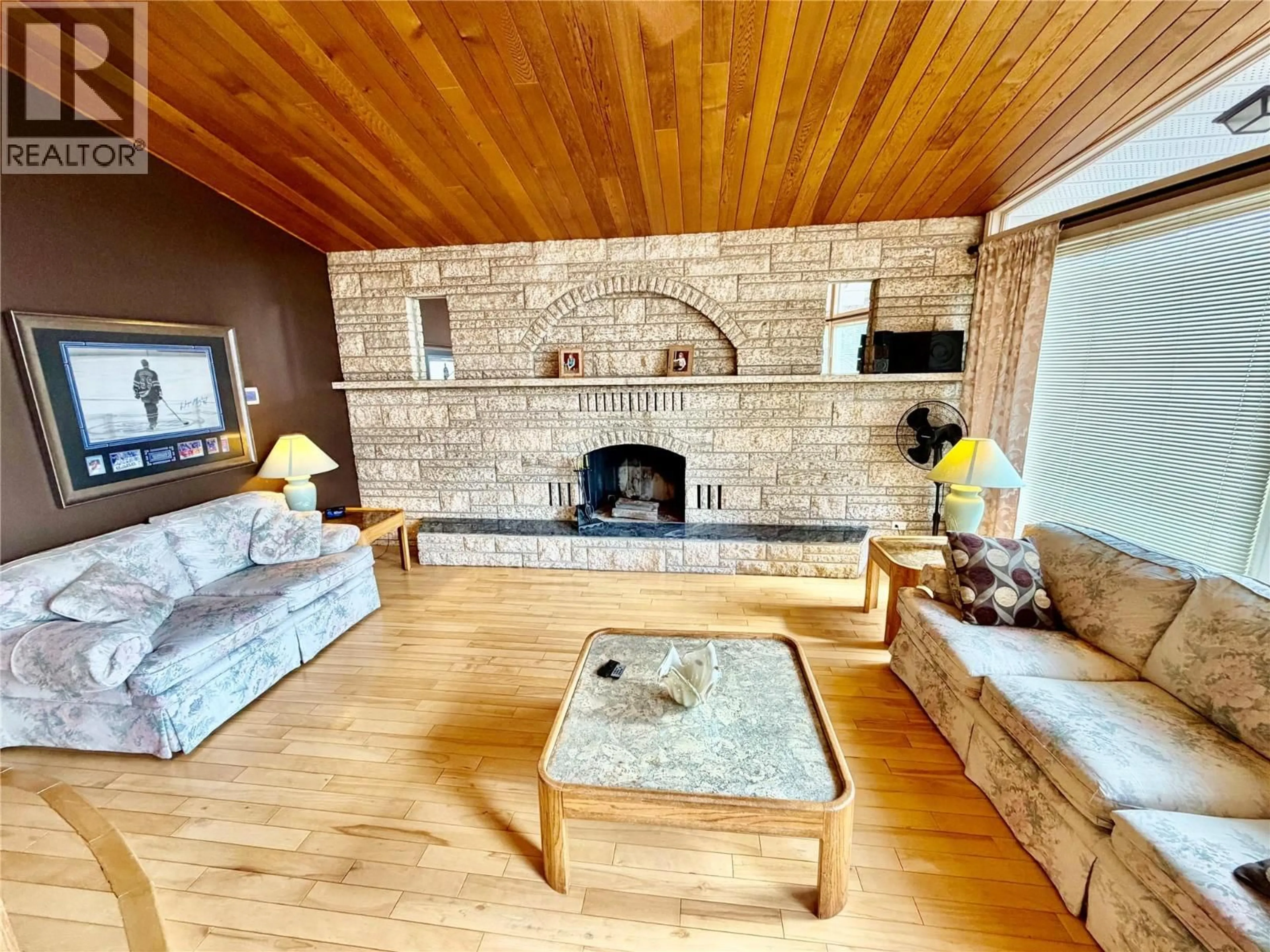 Living room with furniture, wood/laminate floor for 10704 PINECREST LANE, Dawson Creek British Columbia V1G4M6
