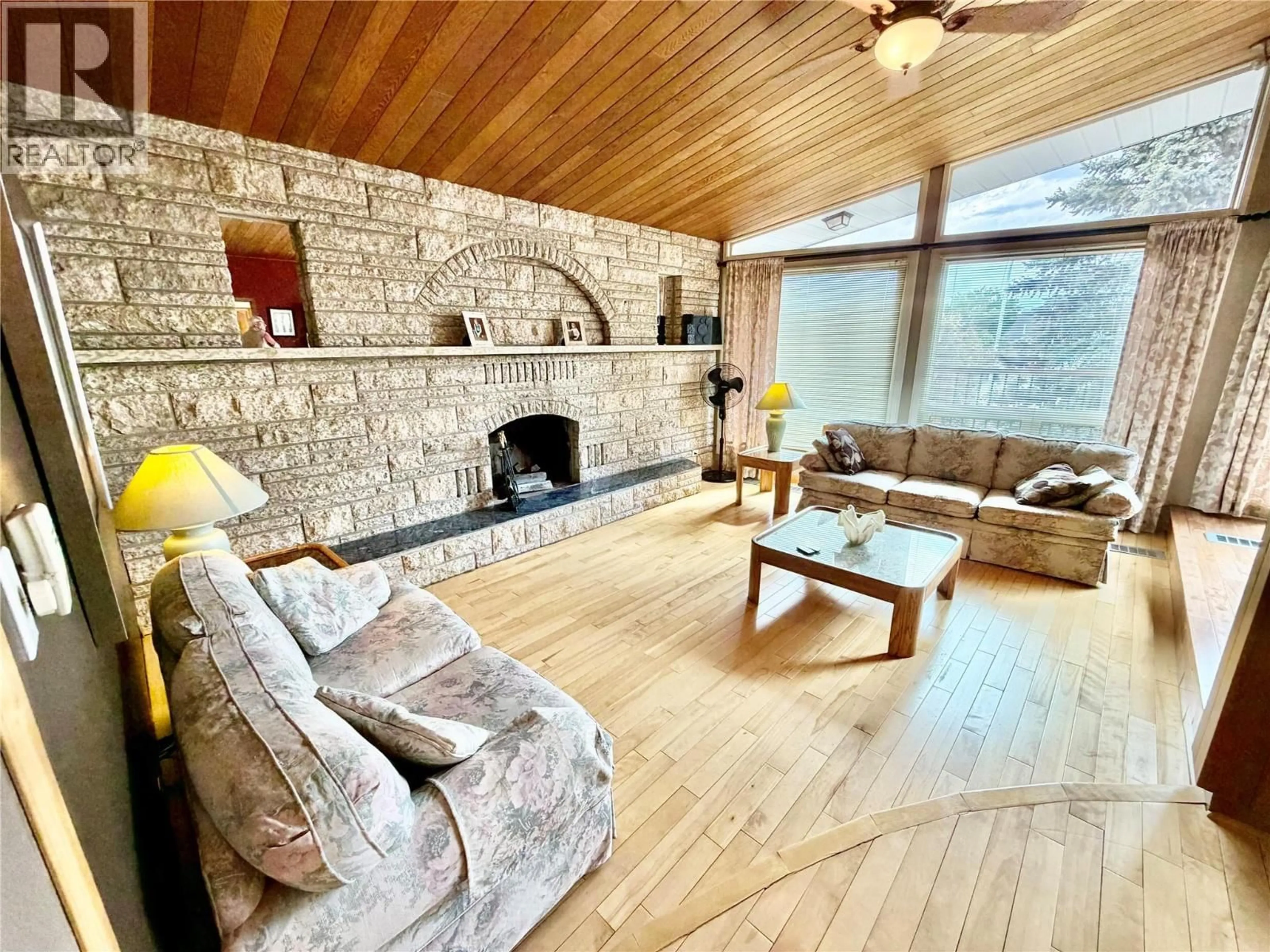 Living room with furniture, wood/laminate floor for 10704 PINECREST LANE, Dawson Creek British Columbia V1G4M6