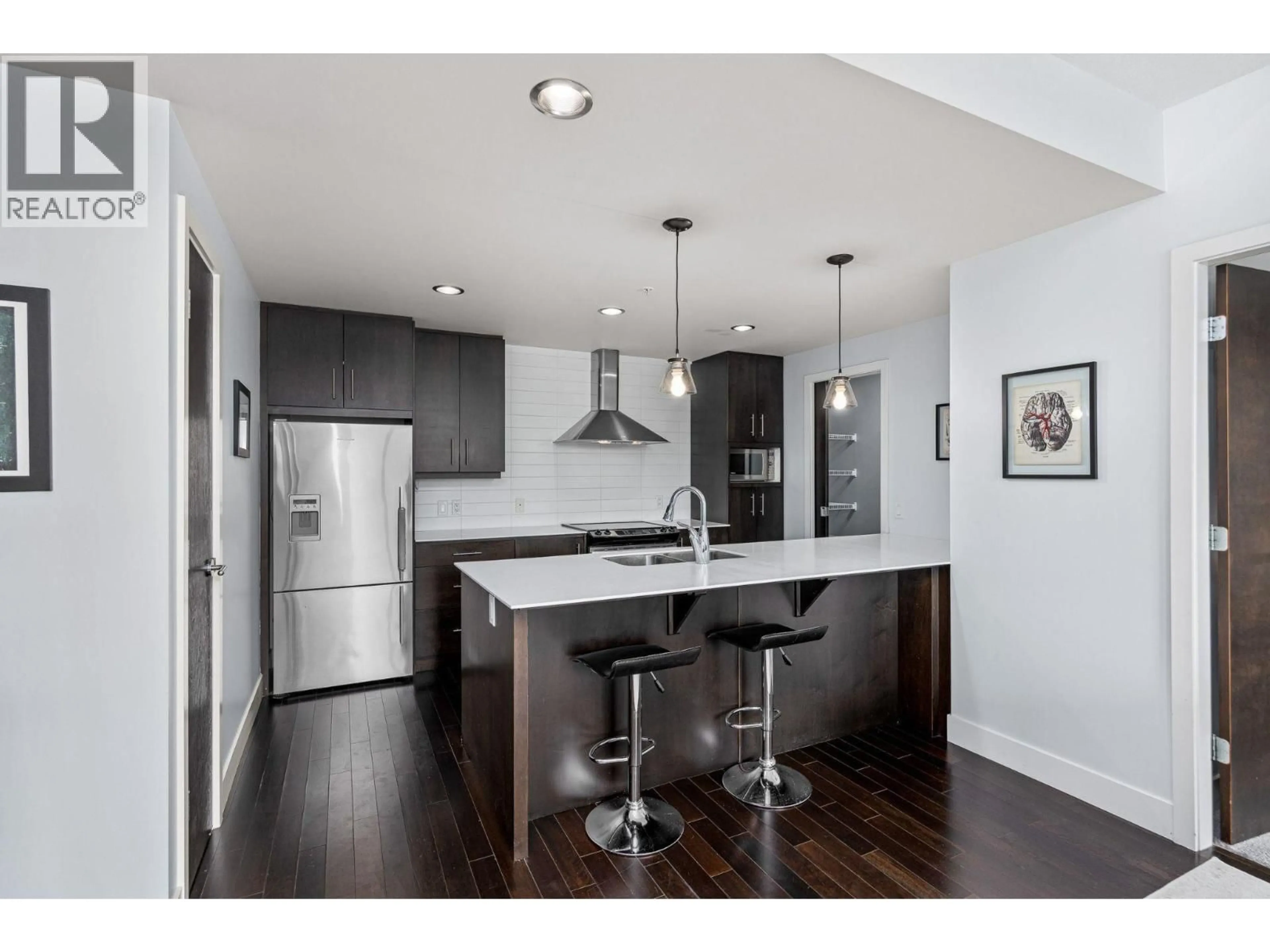 Open concept kitchen, wood/laminate floor for 807 - 2040 SPRINGFIELD ROAD, Kelowna British Columbia V1Y5V8