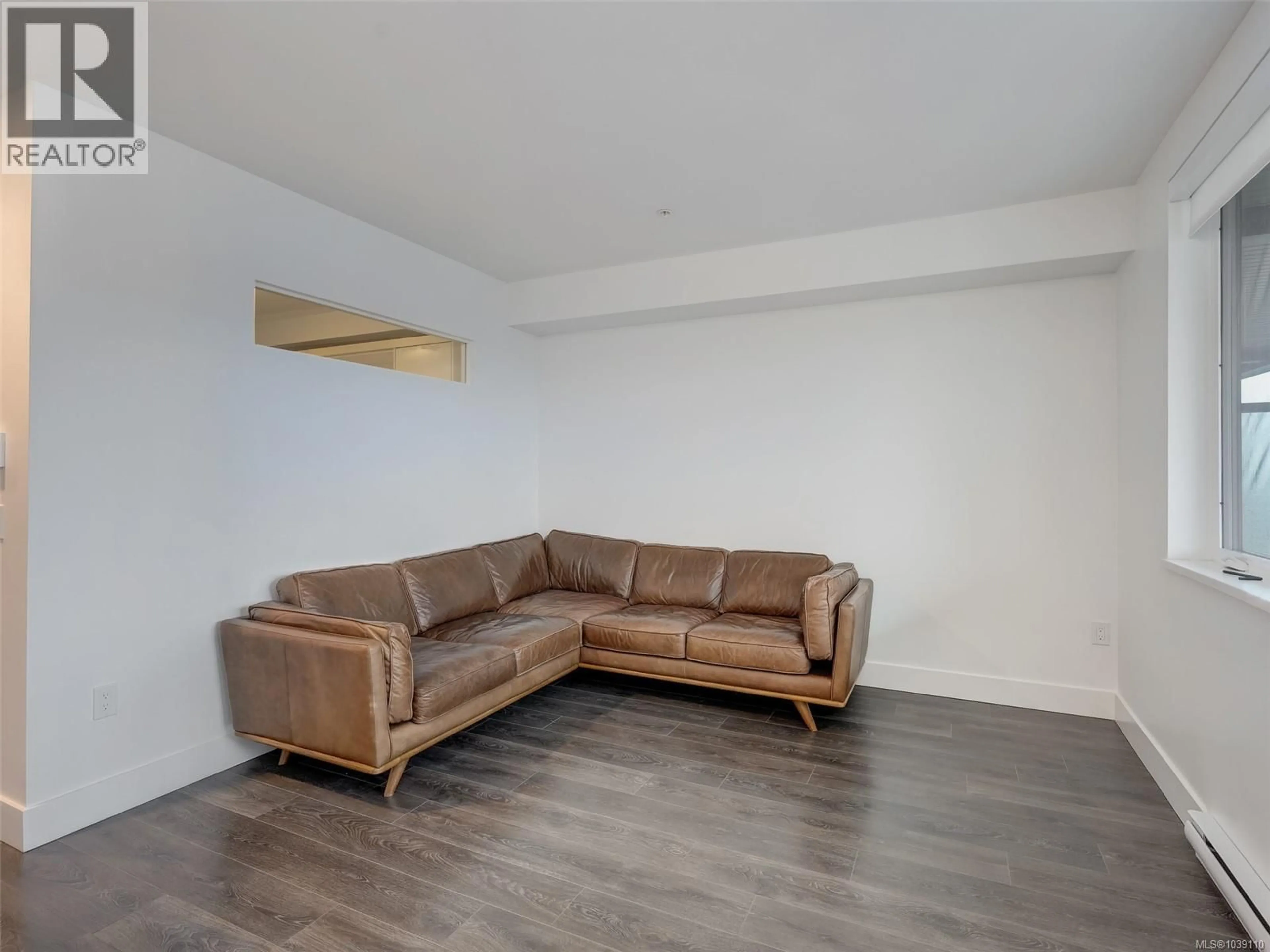 Living room with furniture, wood/laminate floor for 412 - 2461 SIDNEY AVENUE, Sidney British Columbia V8L1Y8