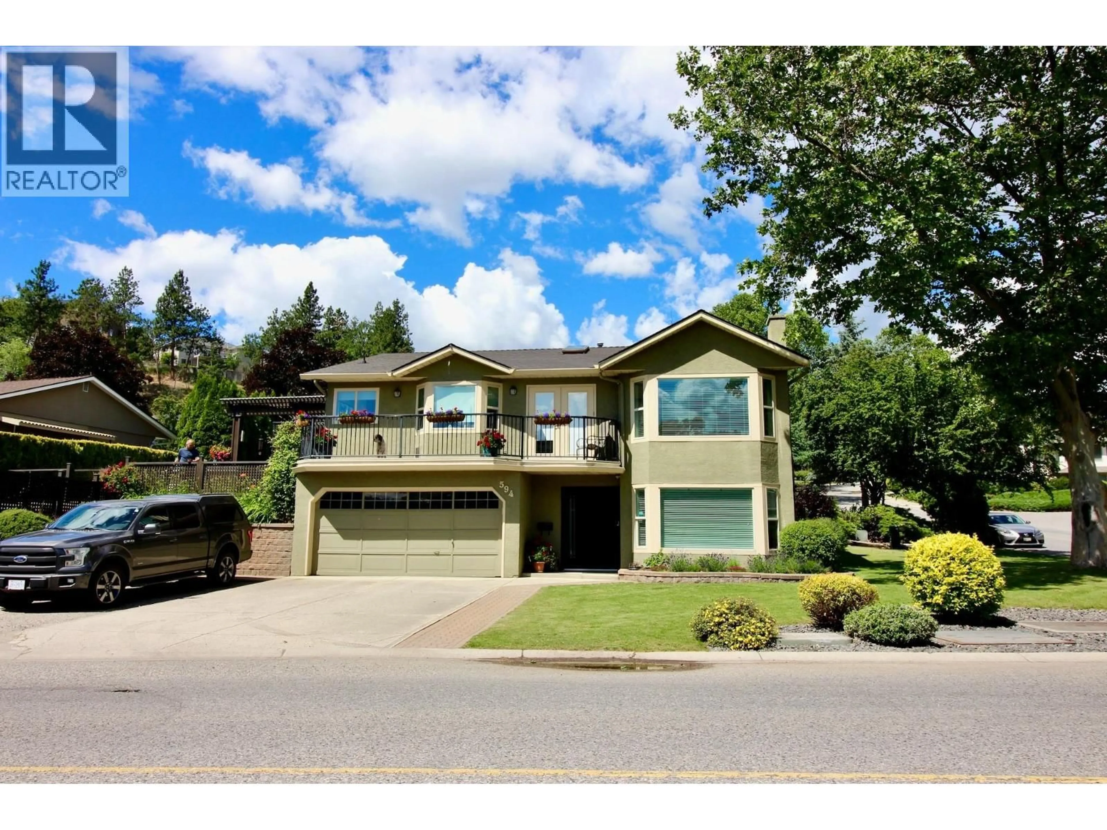 Home with vinyl exterior material, street for 594 GLENMEADOWS ROAD, Kelowna British Columbia V1V1P3
