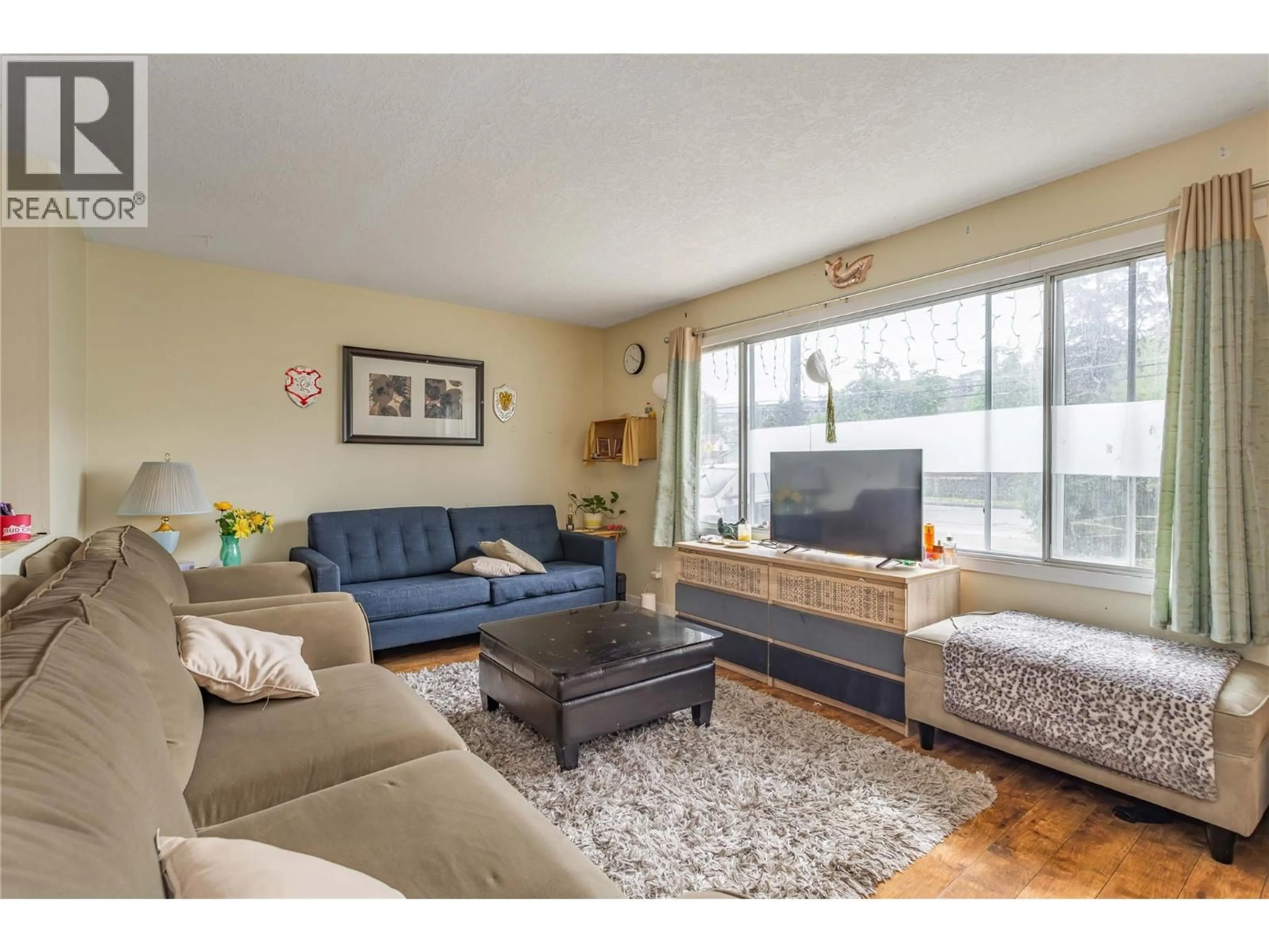 Living room with furniture, wood/laminate floor for 1806 43 STREET, Vernon British Columbia V1T6W8
