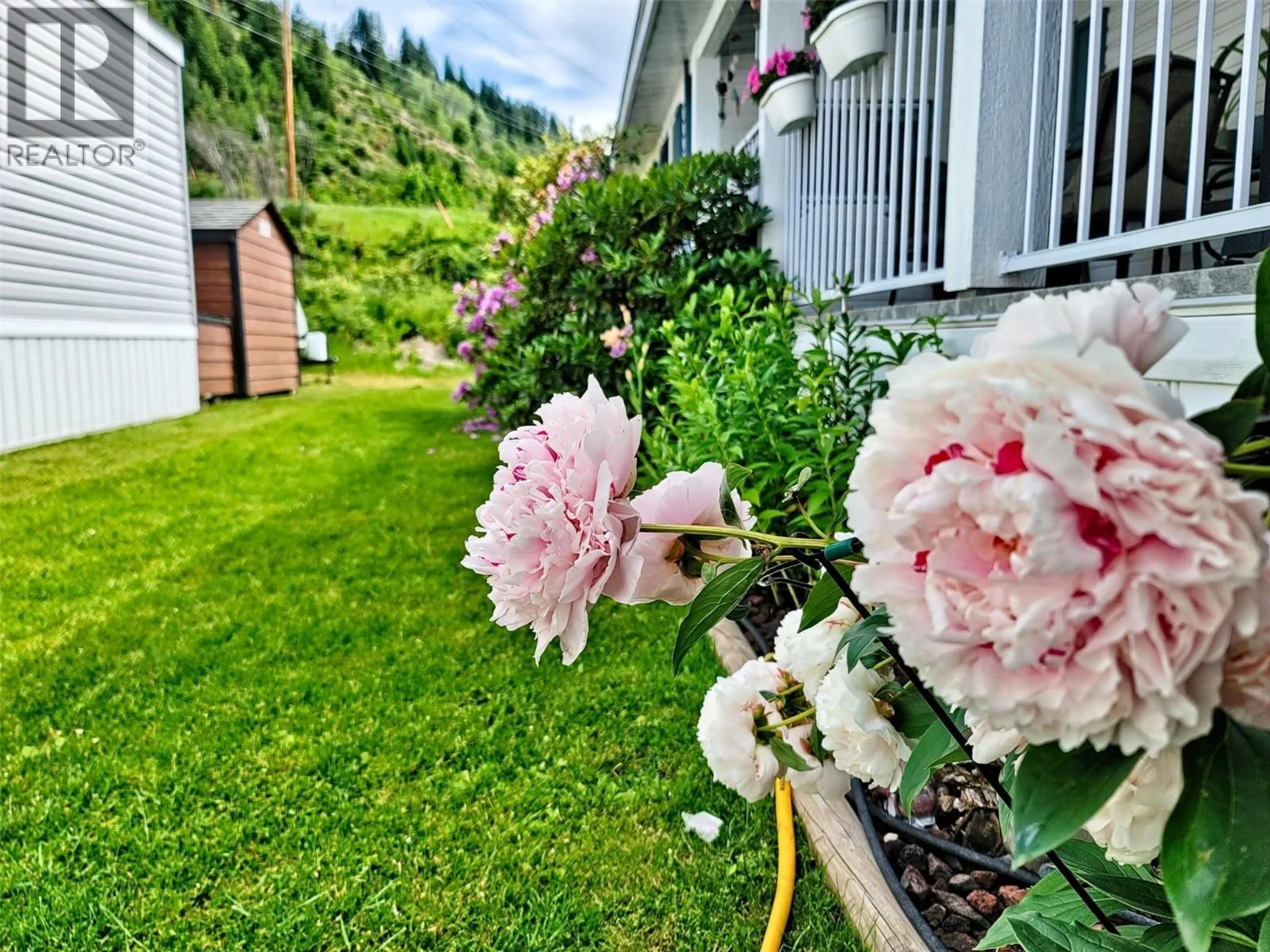 A pic from outside/outdoor area/front of a property/back of a property/a pic from drone, mountain view for 9 - 651 ROSEDALE ROAD, Castlegar British Columbia V1N4L2