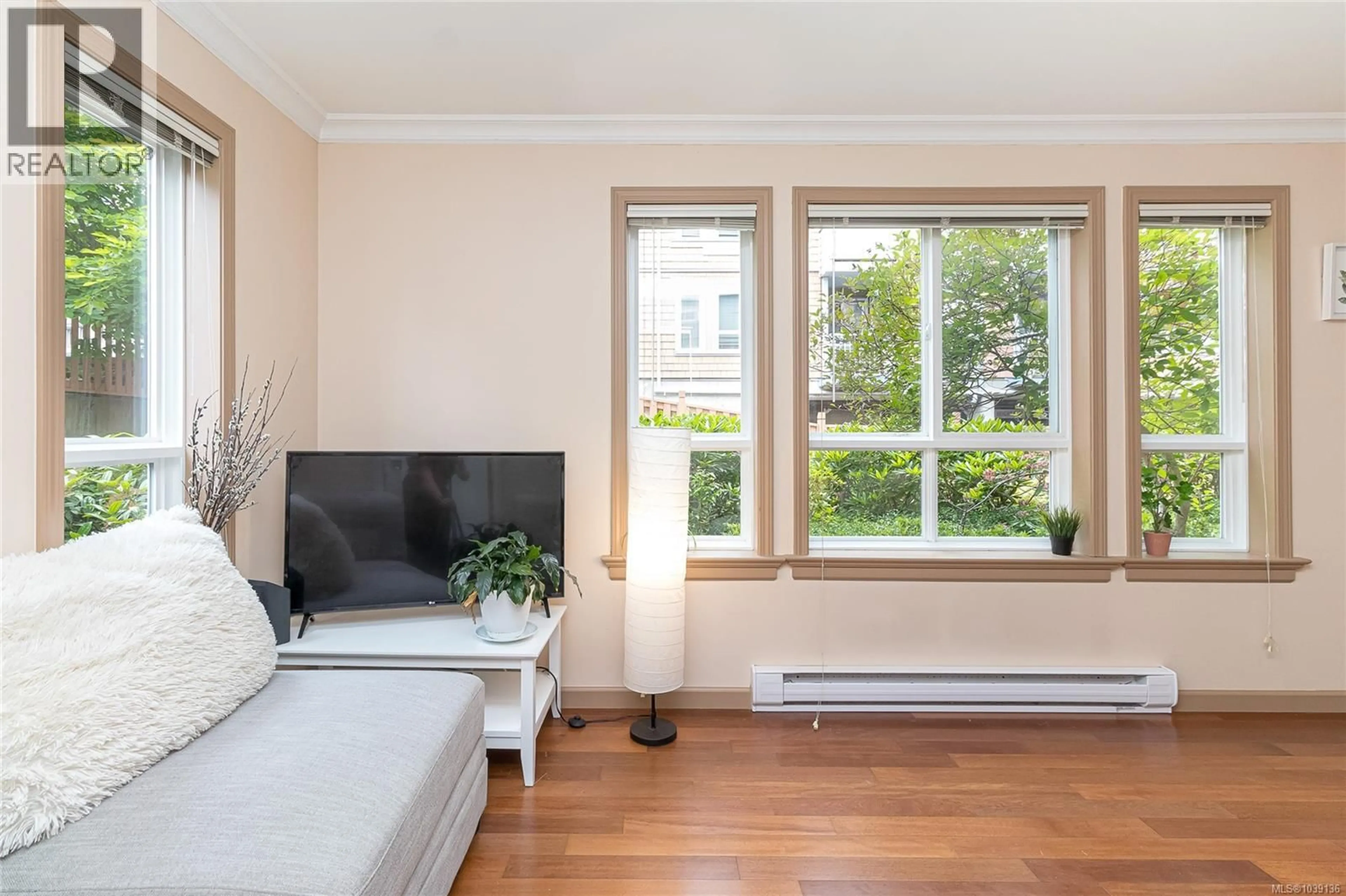 Living room with furniture, wood/laminate floor for 105 - 1514 CHURCH AVENUE, Saanich British Columbia V8P0A3