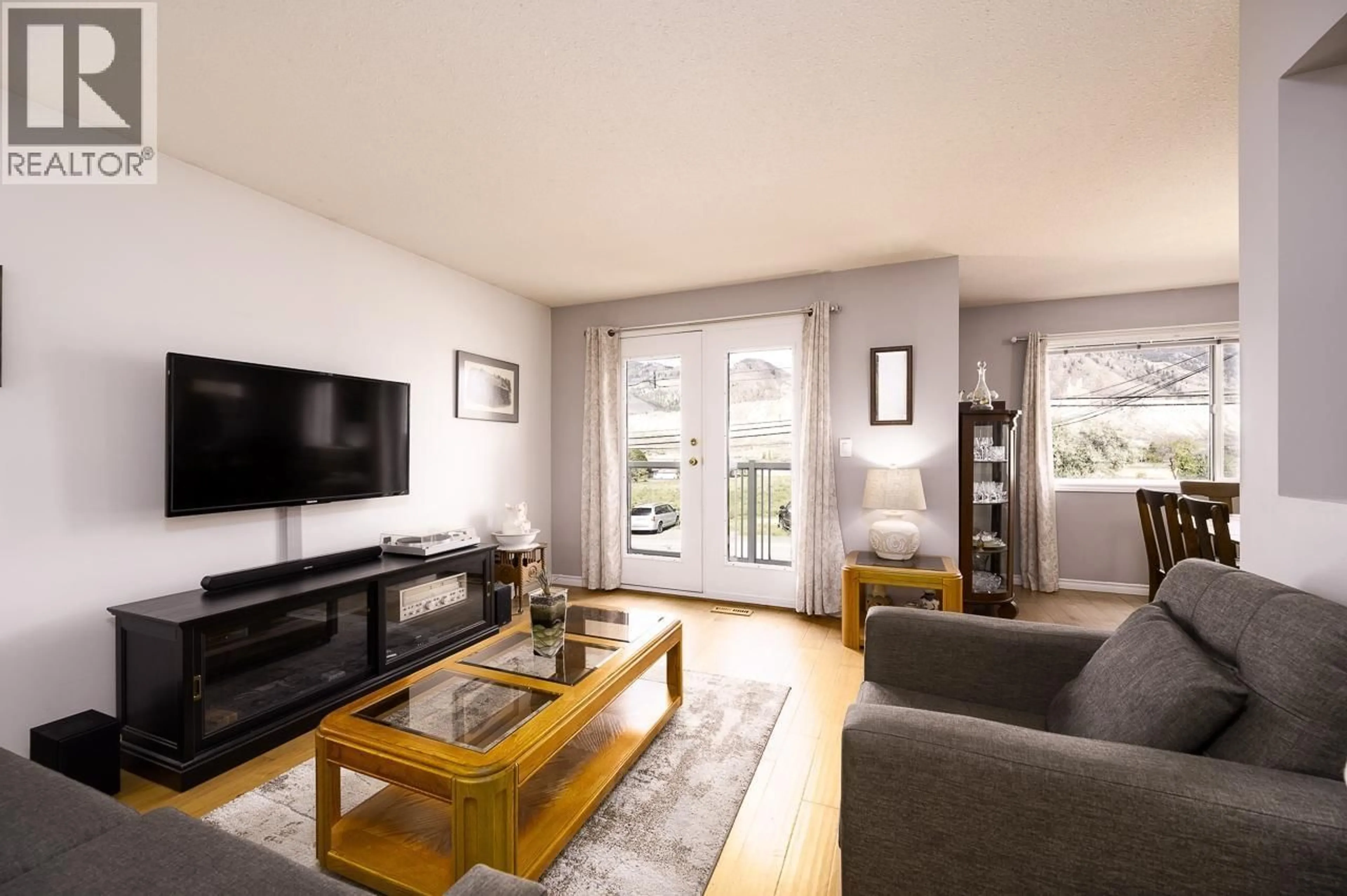 Living room with furniture, wood/laminate floor for 6037 DALLAS DRIVE, Kamloops British Columbia V2C5Z9