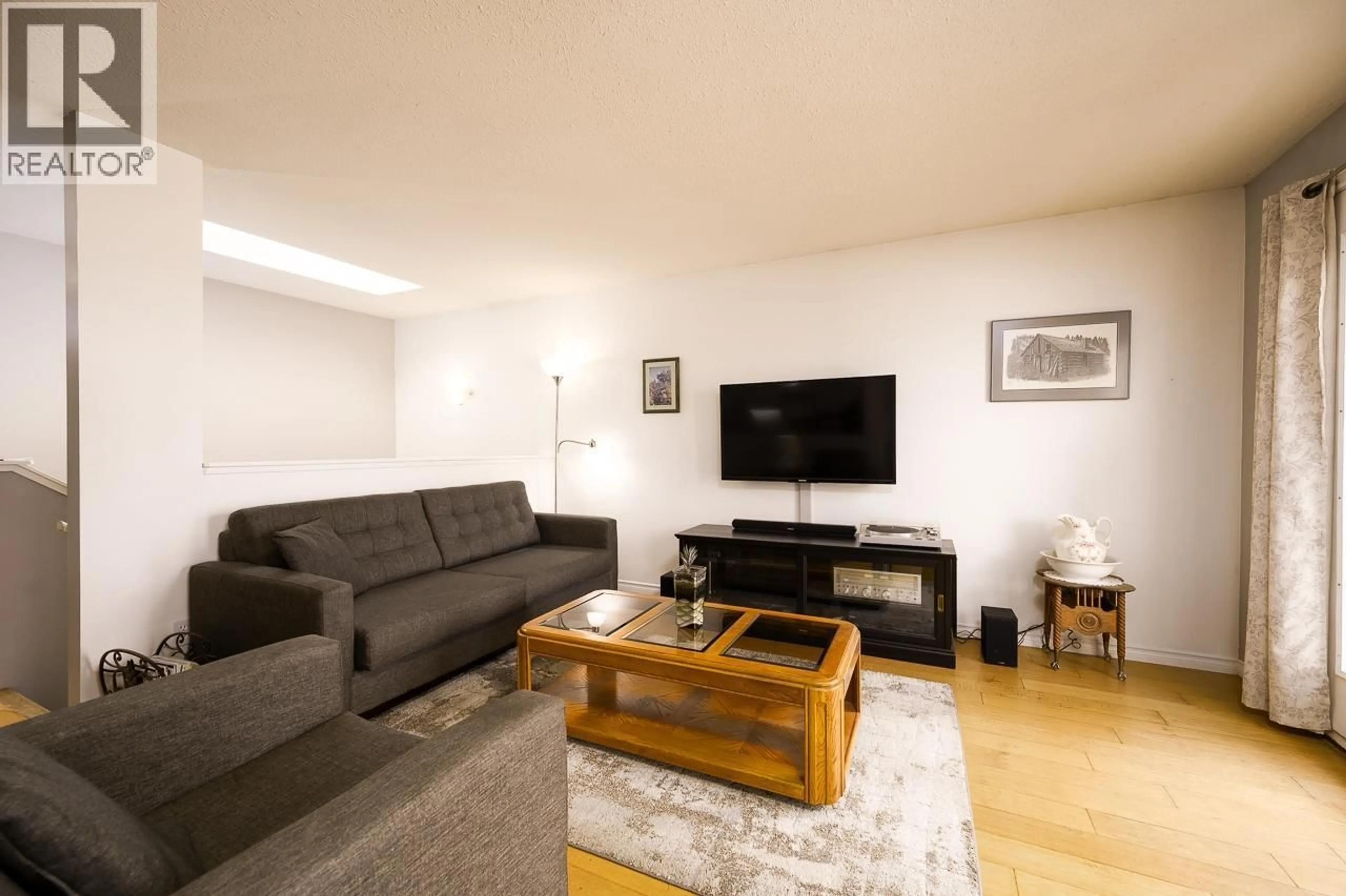 Living room with furniture, wood/laminate floor for 6037 DALLAS DRIVE, Kamloops British Columbia V2C5Z9