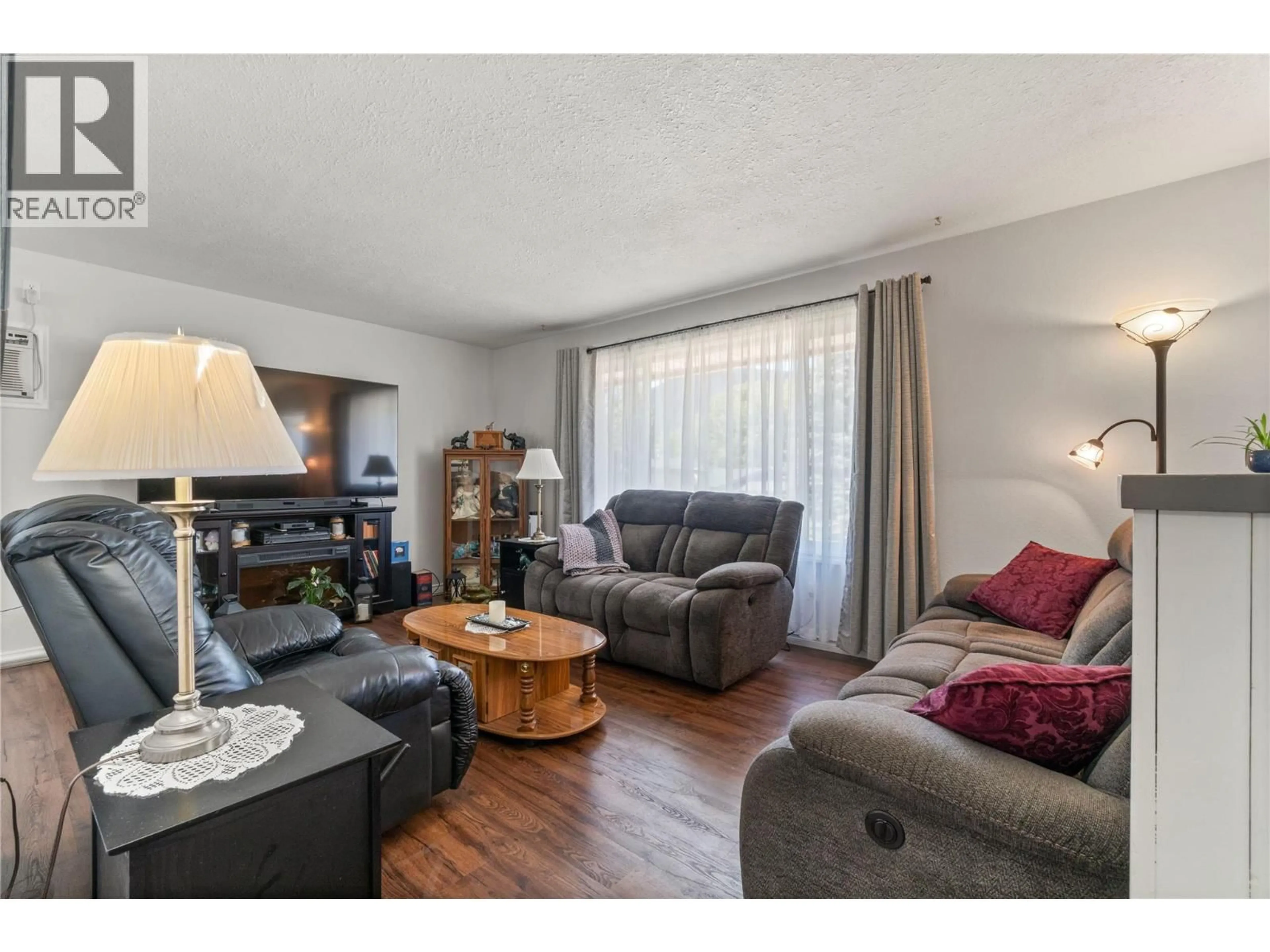 Living room with furniture, wood/laminate floor for 4750 71 AVENUE NORTHEAST, Salmon Arm British Columbia V0E1K0