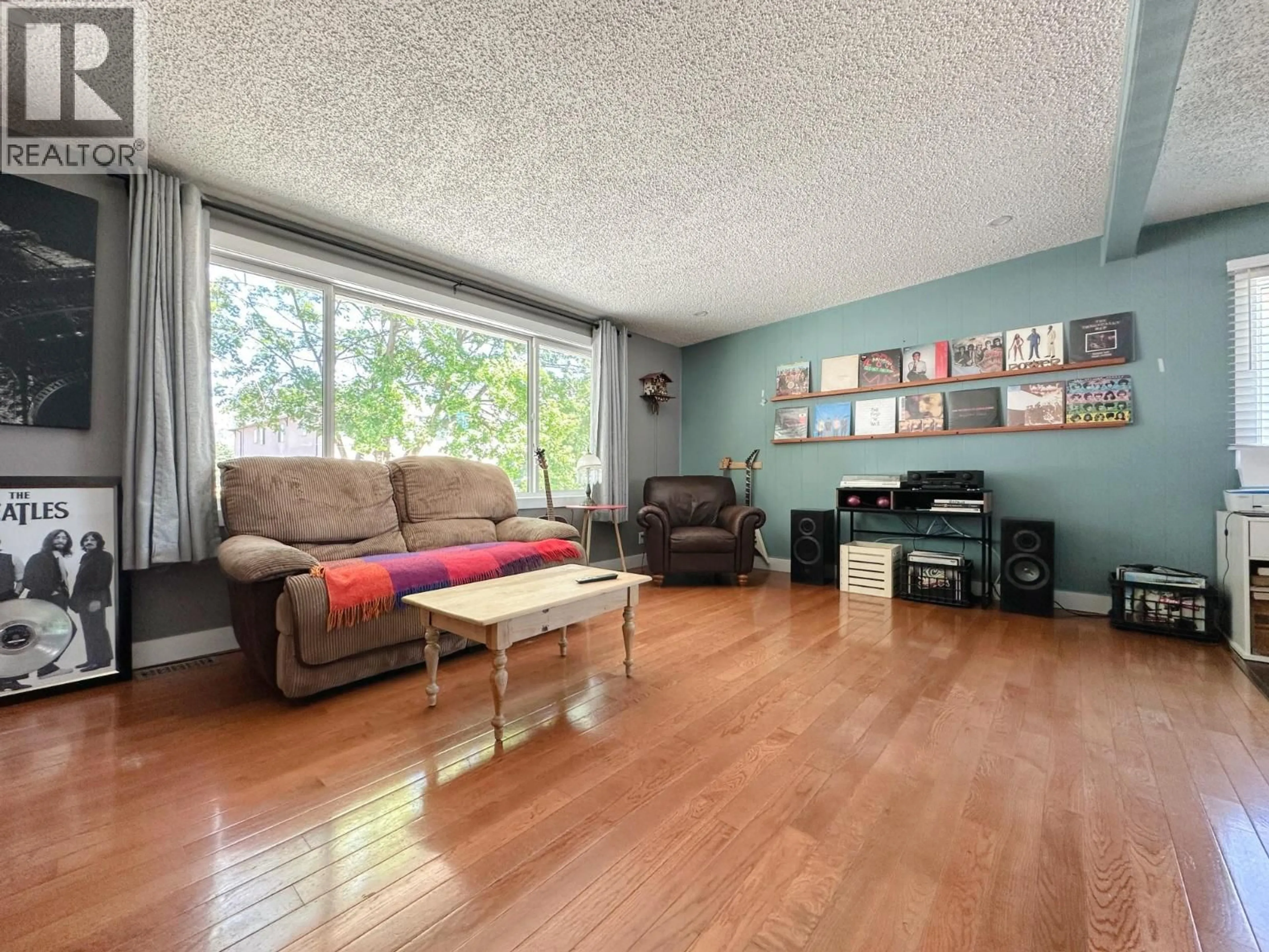 Living room with furniture, wood/laminate floor for 8505 70TH AVENUE, Osoyoos British Columbia V0H1V0
