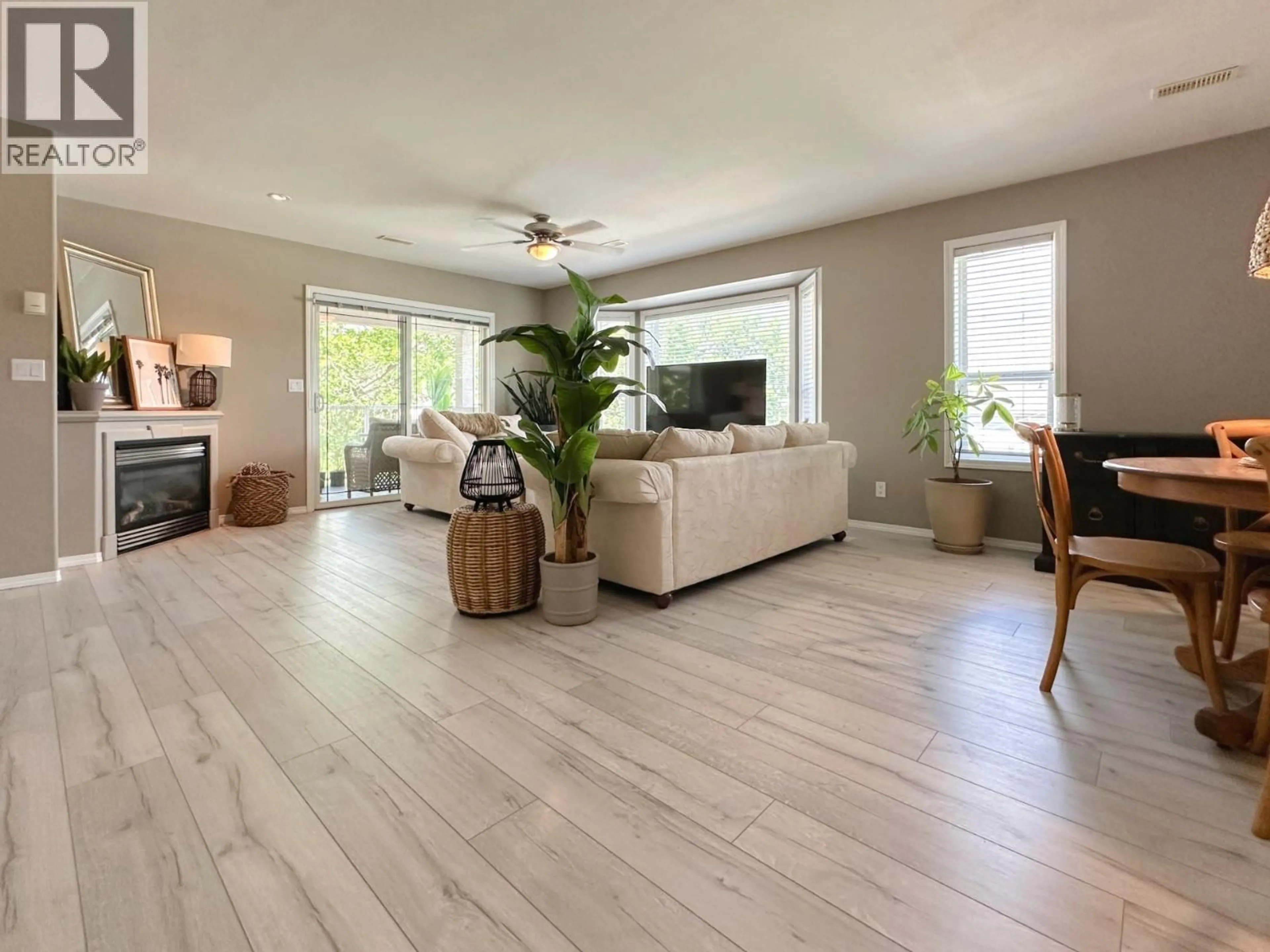 Living room with furniture, wood/laminate floor for 3 - 8507 70TH AVENUE, Osoyoos British Columbia V0H1V0