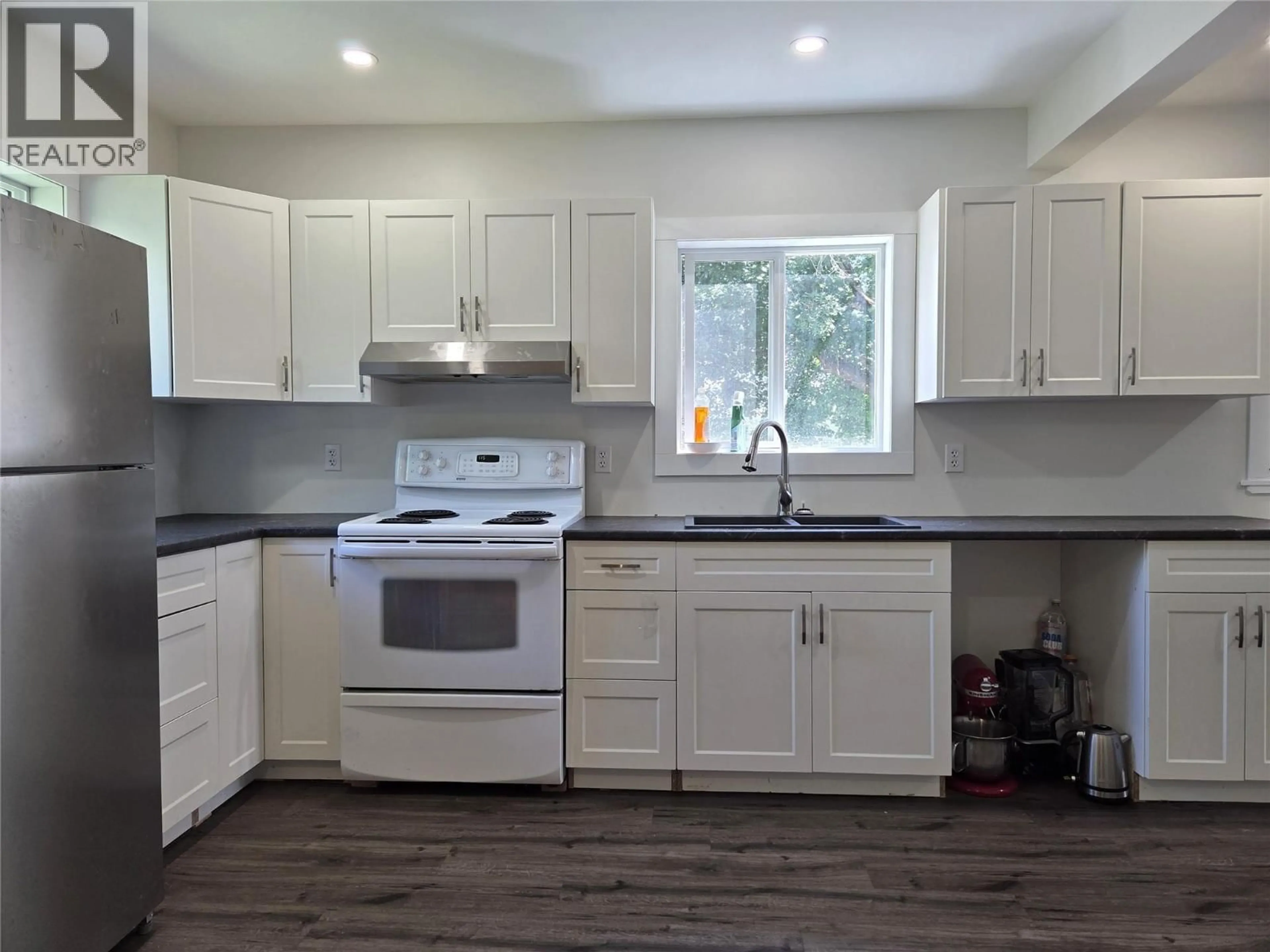 Open concept kitchen, wood/laminate floor for 780 CAMERON AVENUE, Grand Forks British Columbia V0H1H4