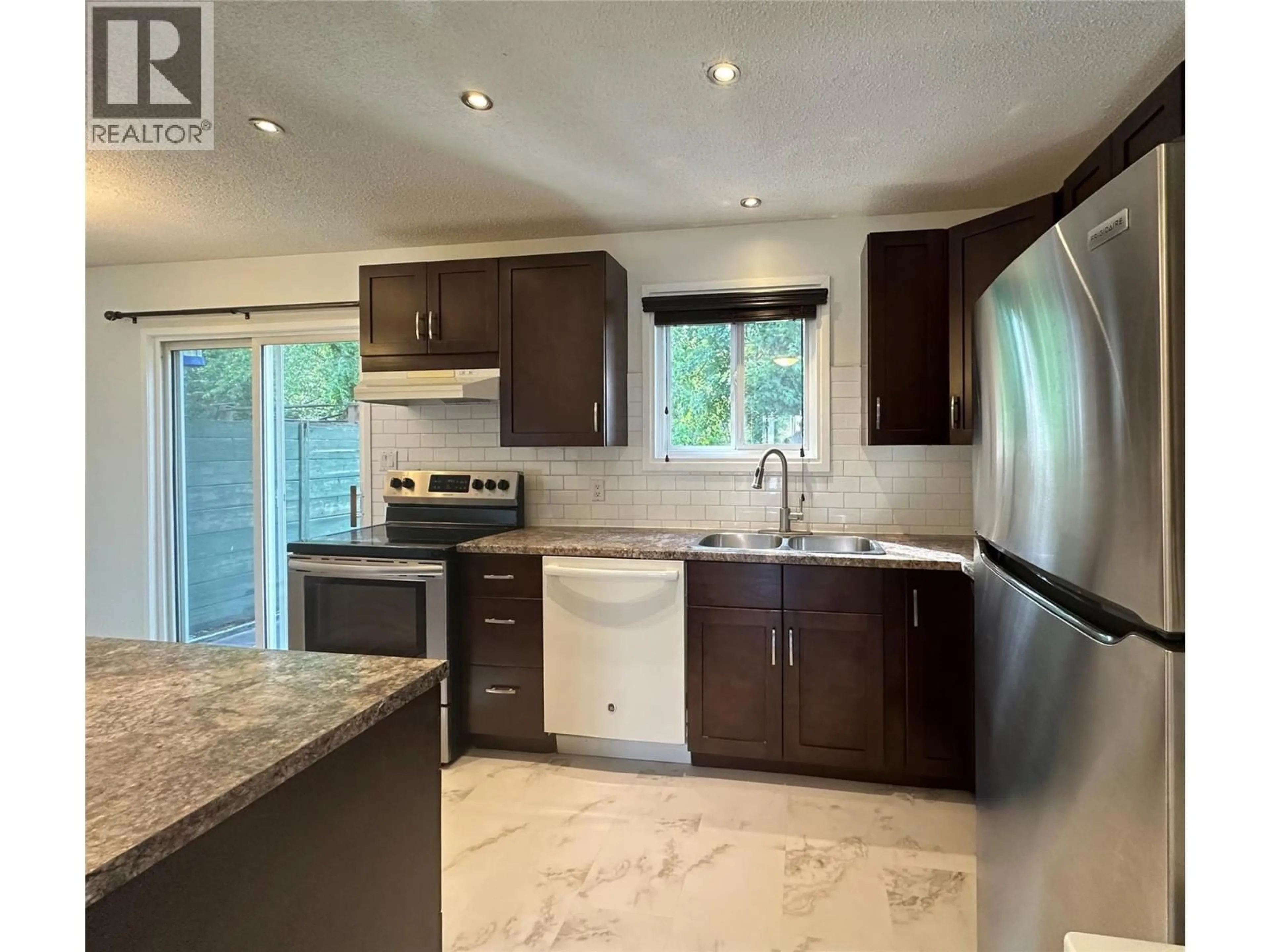 Open concept kitchen, ceramic/tile floor for 14 - 2310 36 STREET, Vernon British Columbia V1T6W2