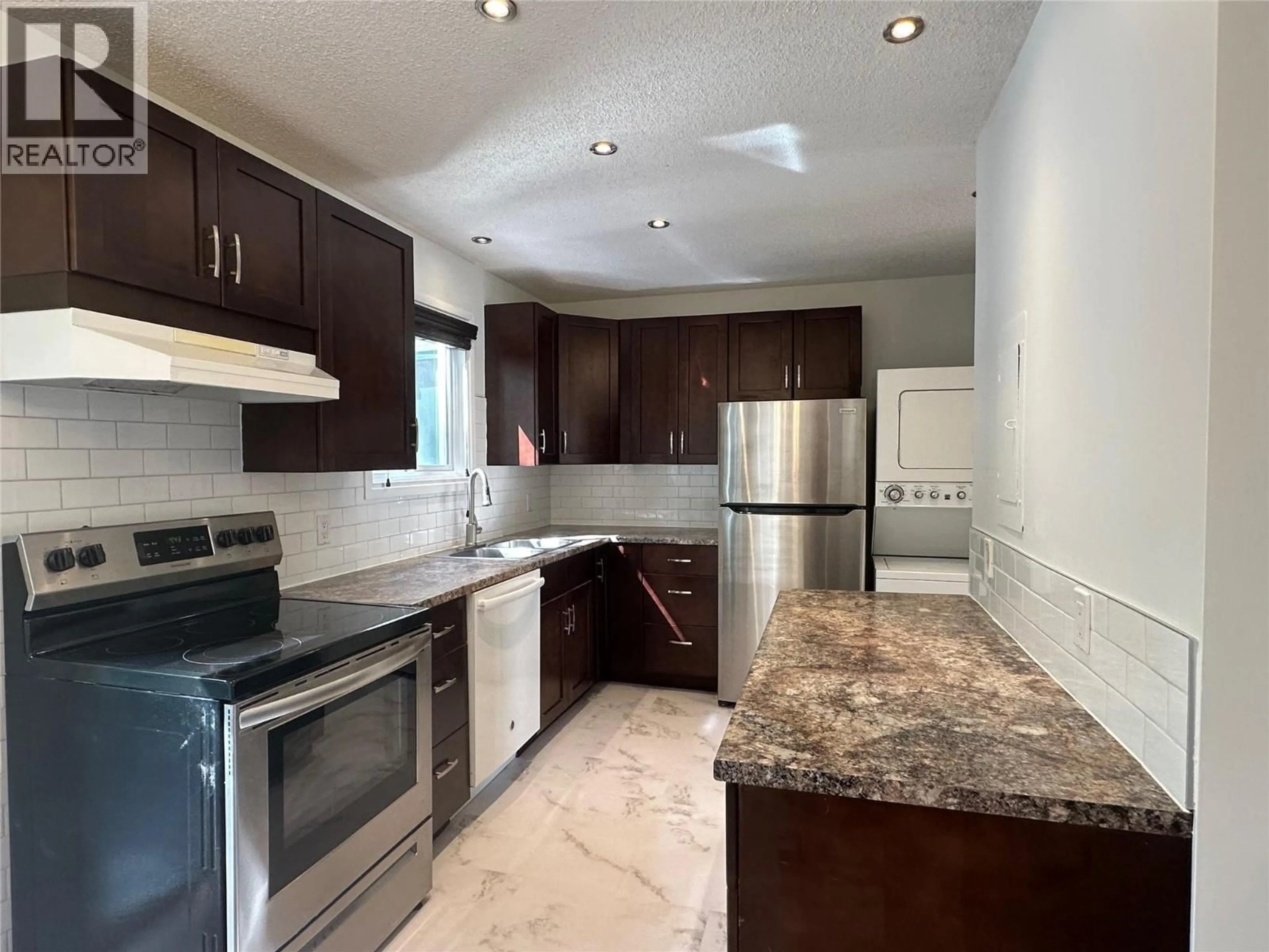 Open concept kitchen, ceramic/tile floor for 14 - 2310 36 STREET, Vernon British Columbia V1T6W2