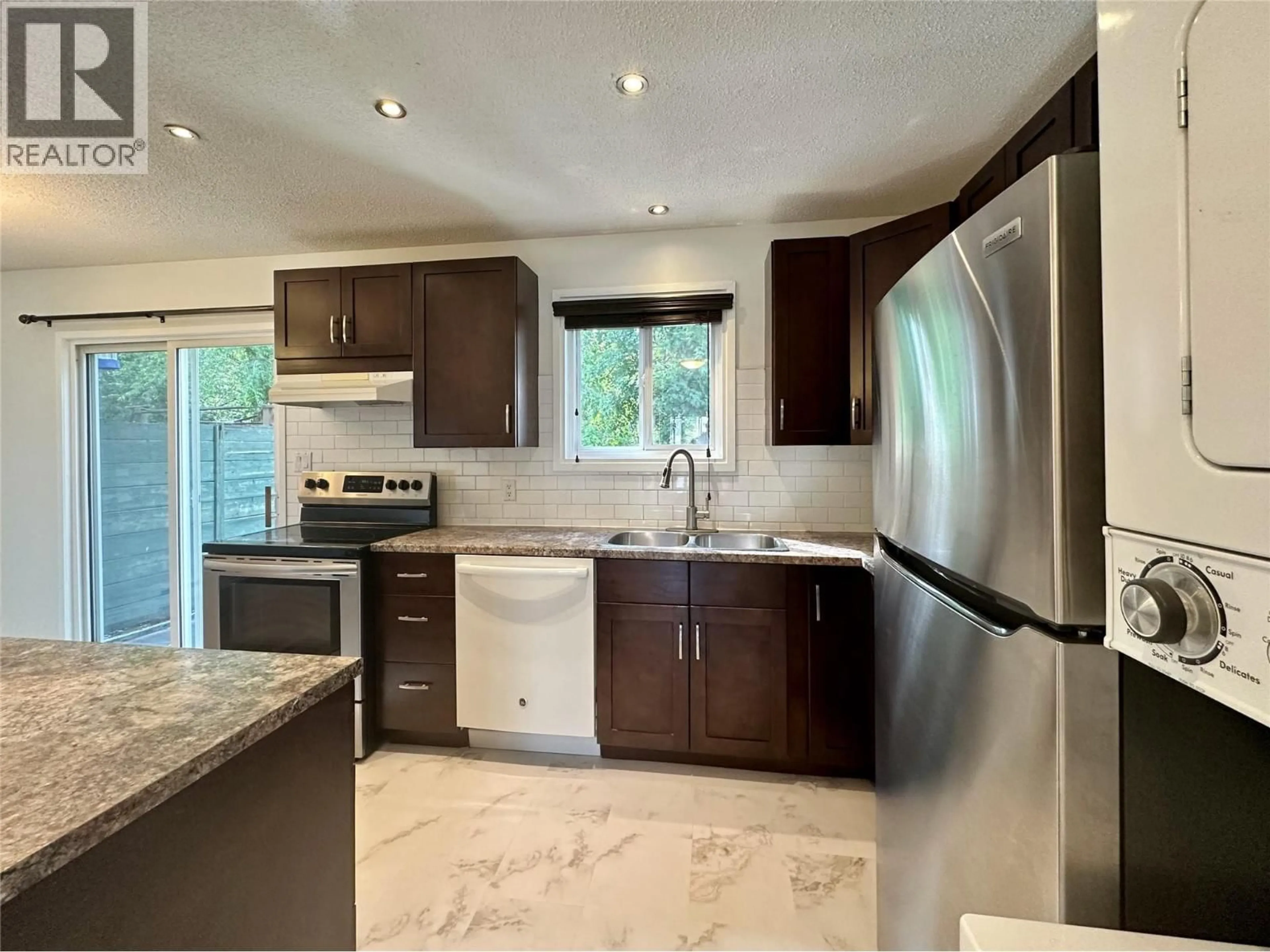 Open concept kitchen, ceramic/tile floor for 14 - 2310 36 STREET, Vernon British Columbia V1T6W2
