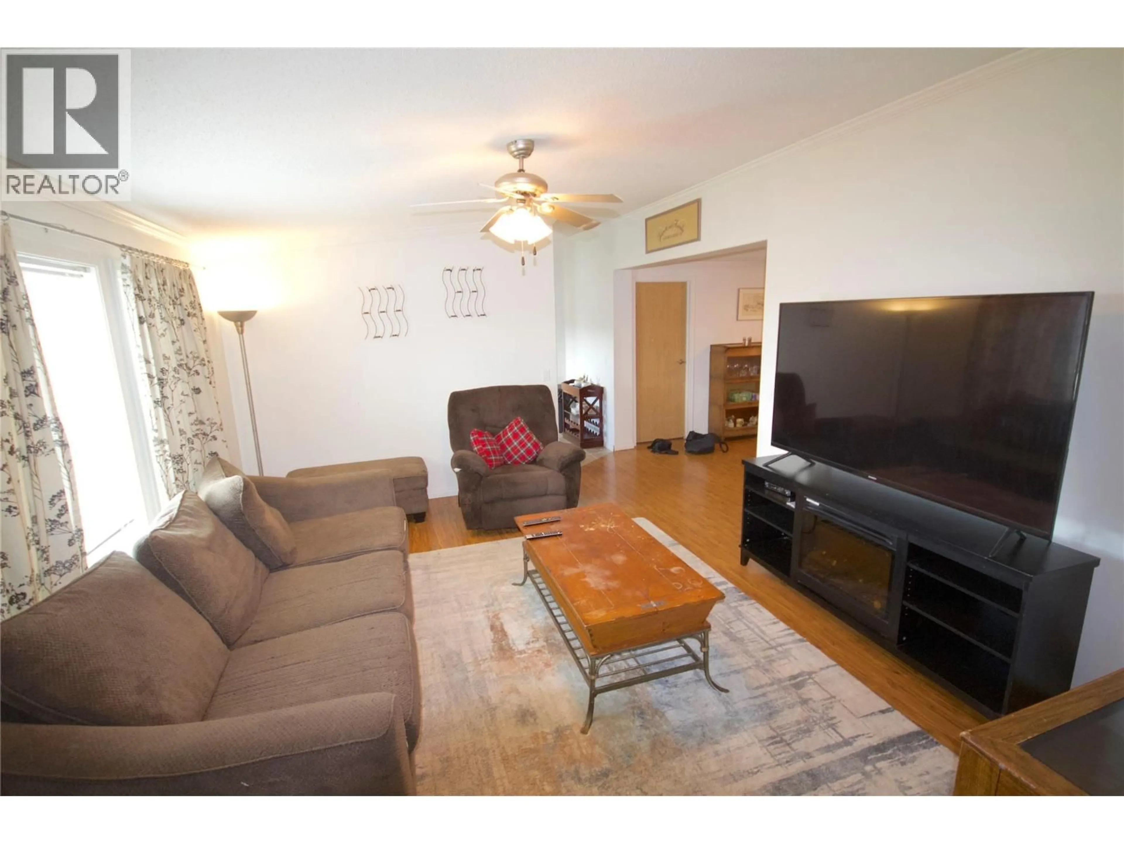 Living room with furniture, wood/laminate floor for 8420 21 STREET, Dawson Creek British Columbia V1G0G7
