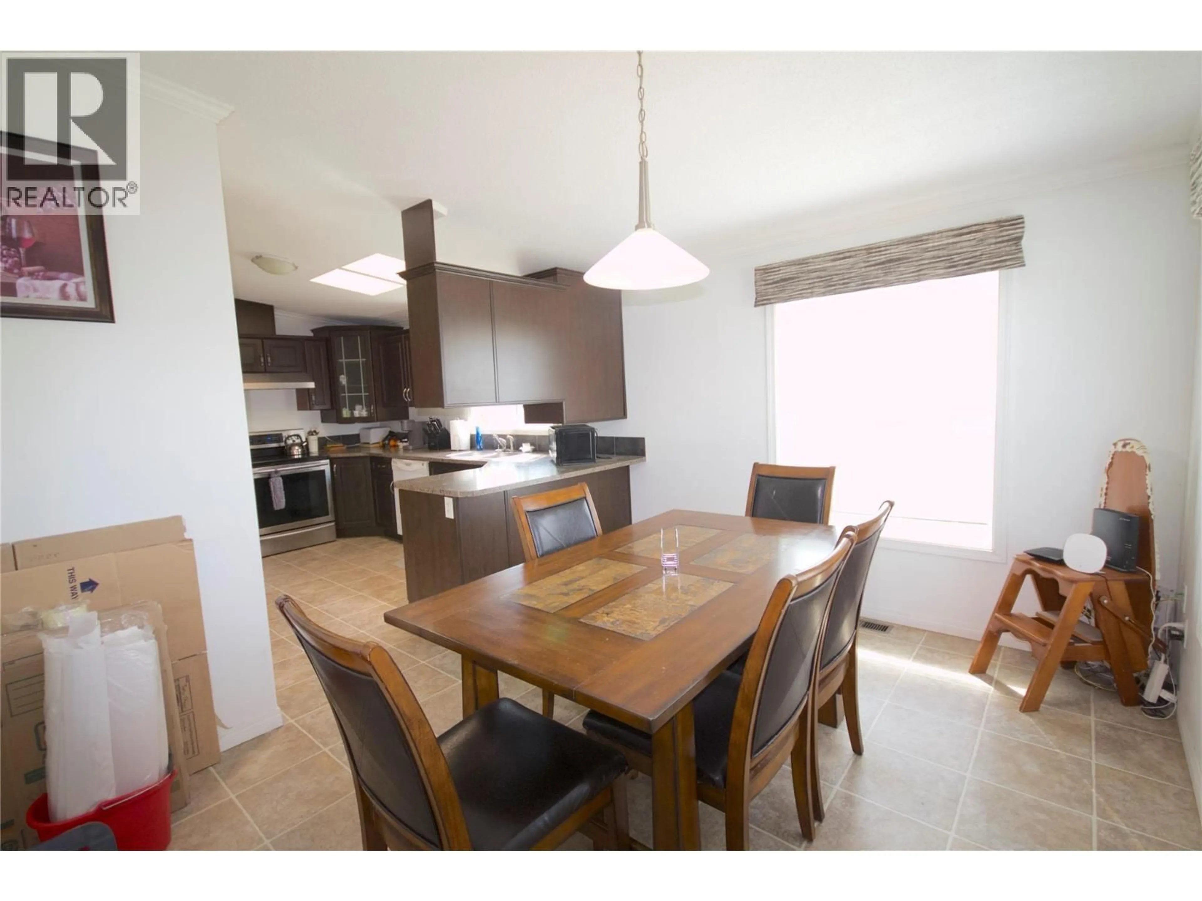 Open concept kitchen, wood/laminate floor for 8420 21 STREET, Dawson Creek British Columbia V1G0G7