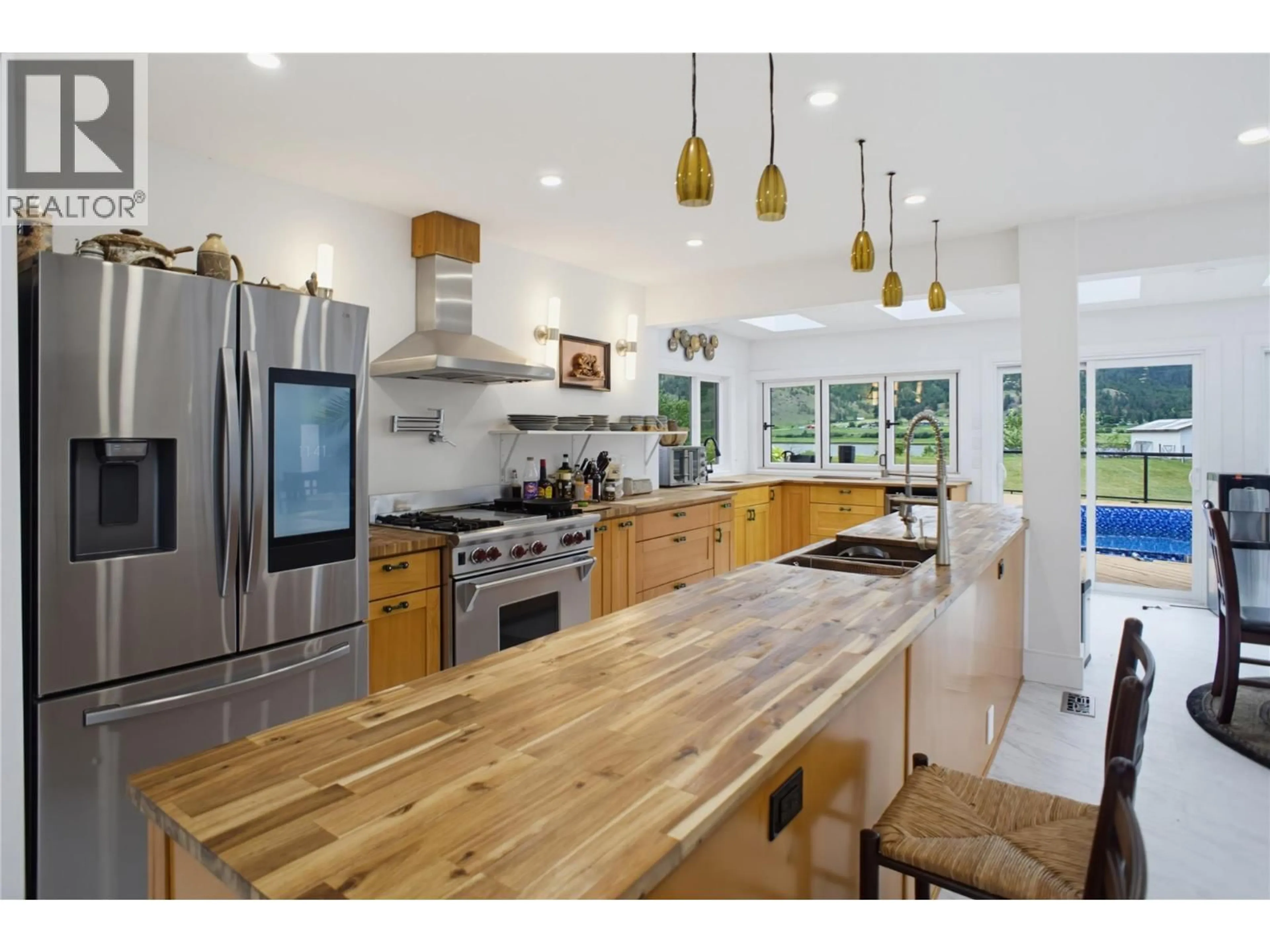 Open concept kitchen, wood/laminate floor for 8576 WESTSYDE ROAD, Kamloops British Columbia V2B8S3