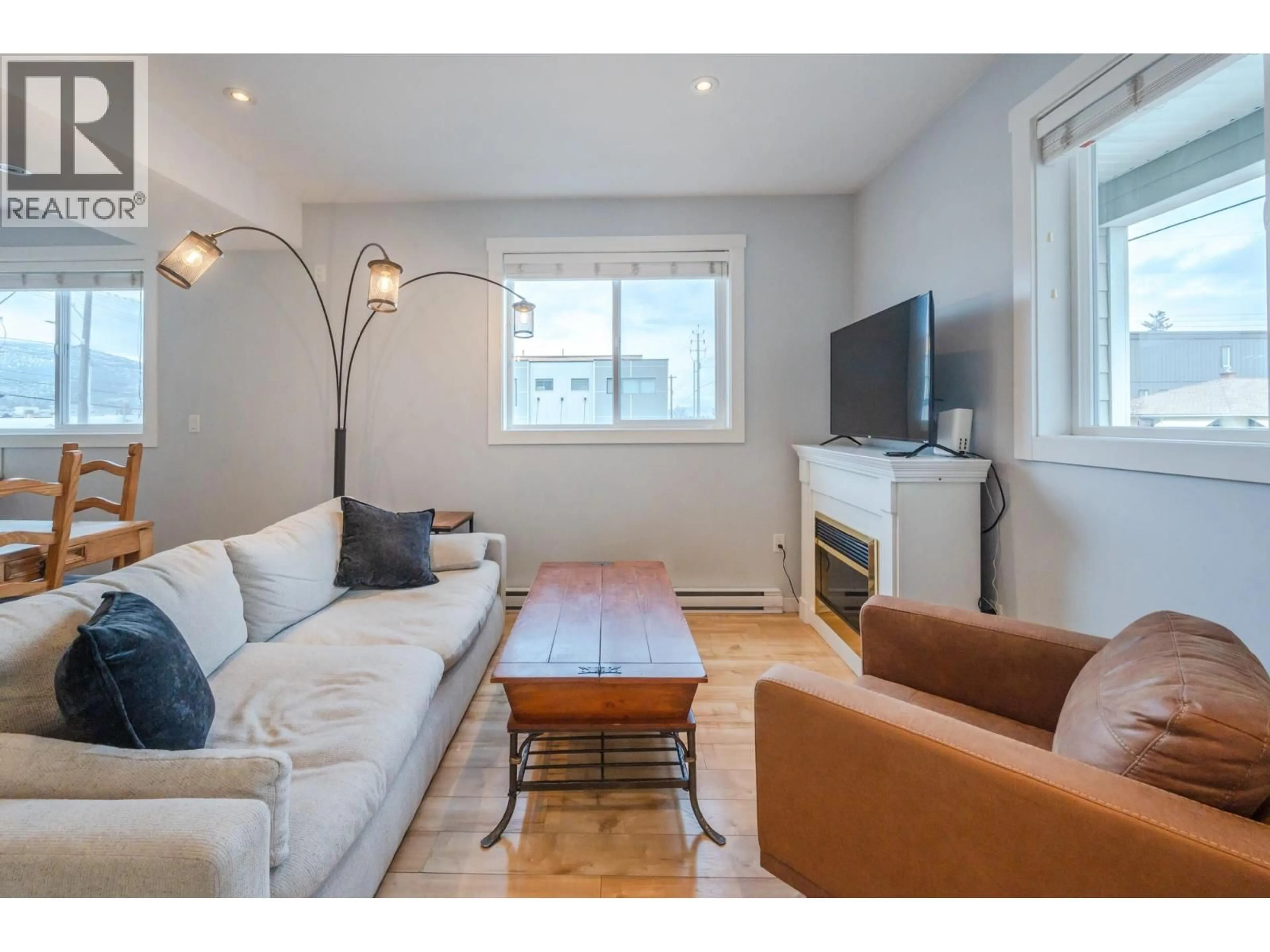 Living room with furniture, wood/laminate floor for 101 - 601 ELLIS STREET, Penticton British Columbia V2A4M5