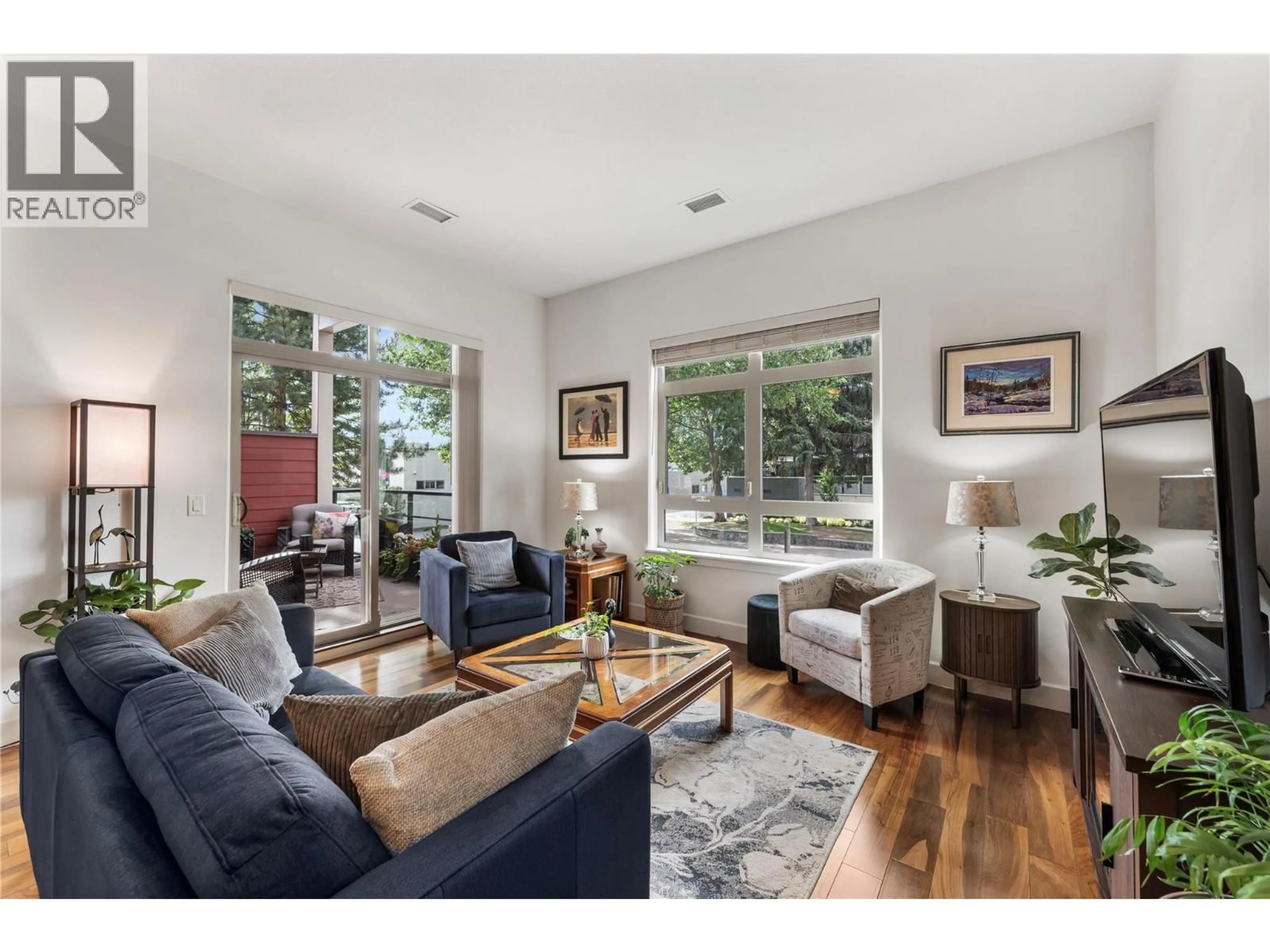 Living room with furniture, wood/laminate floor for 103 - 457 WEST AVENUE, Kelowna British Columbia V1Y4Z3