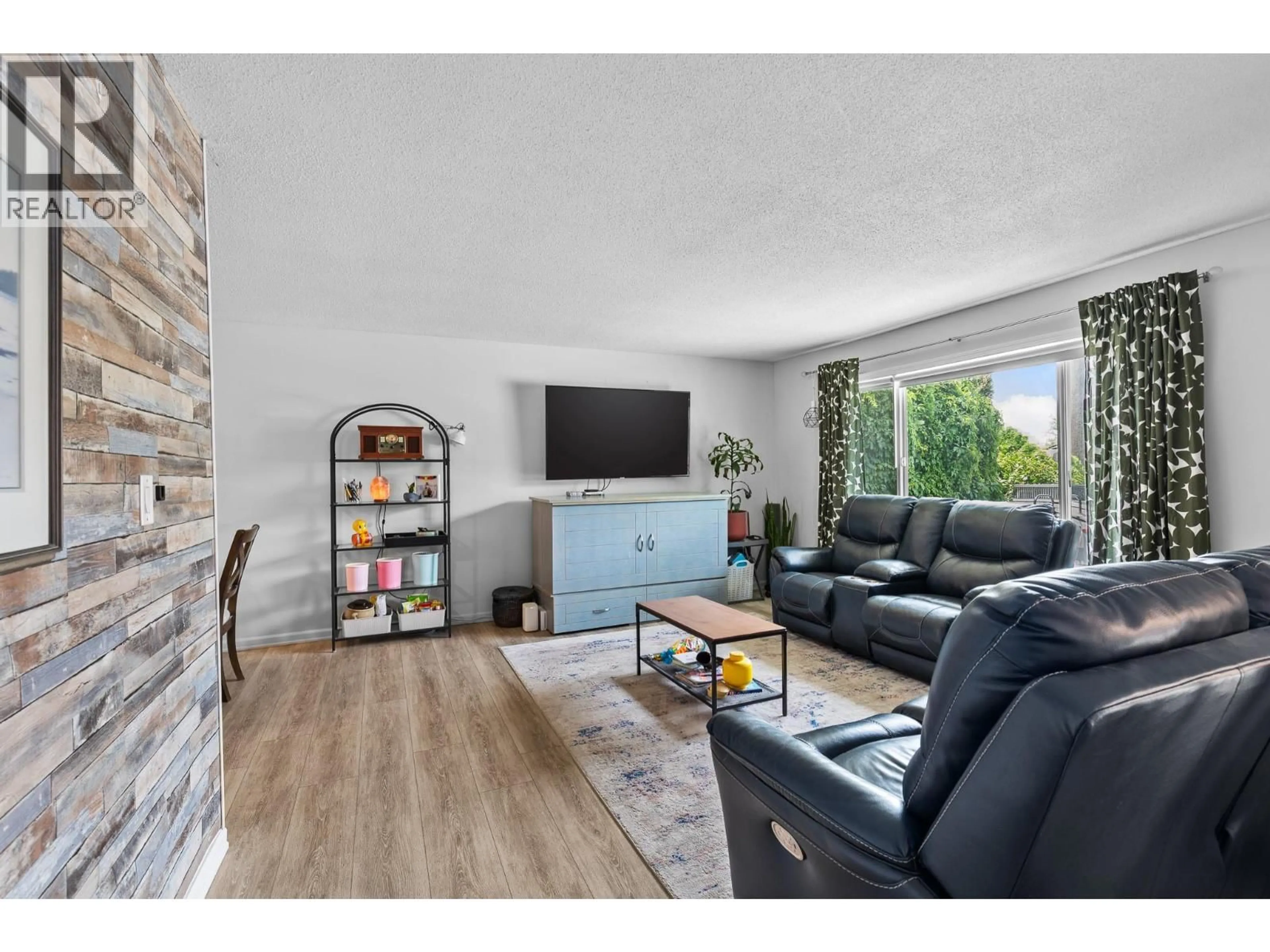 Living room with furniture, wood/laminate floor for 1809 44 STREET, Vernon British Columbia V1T7S2