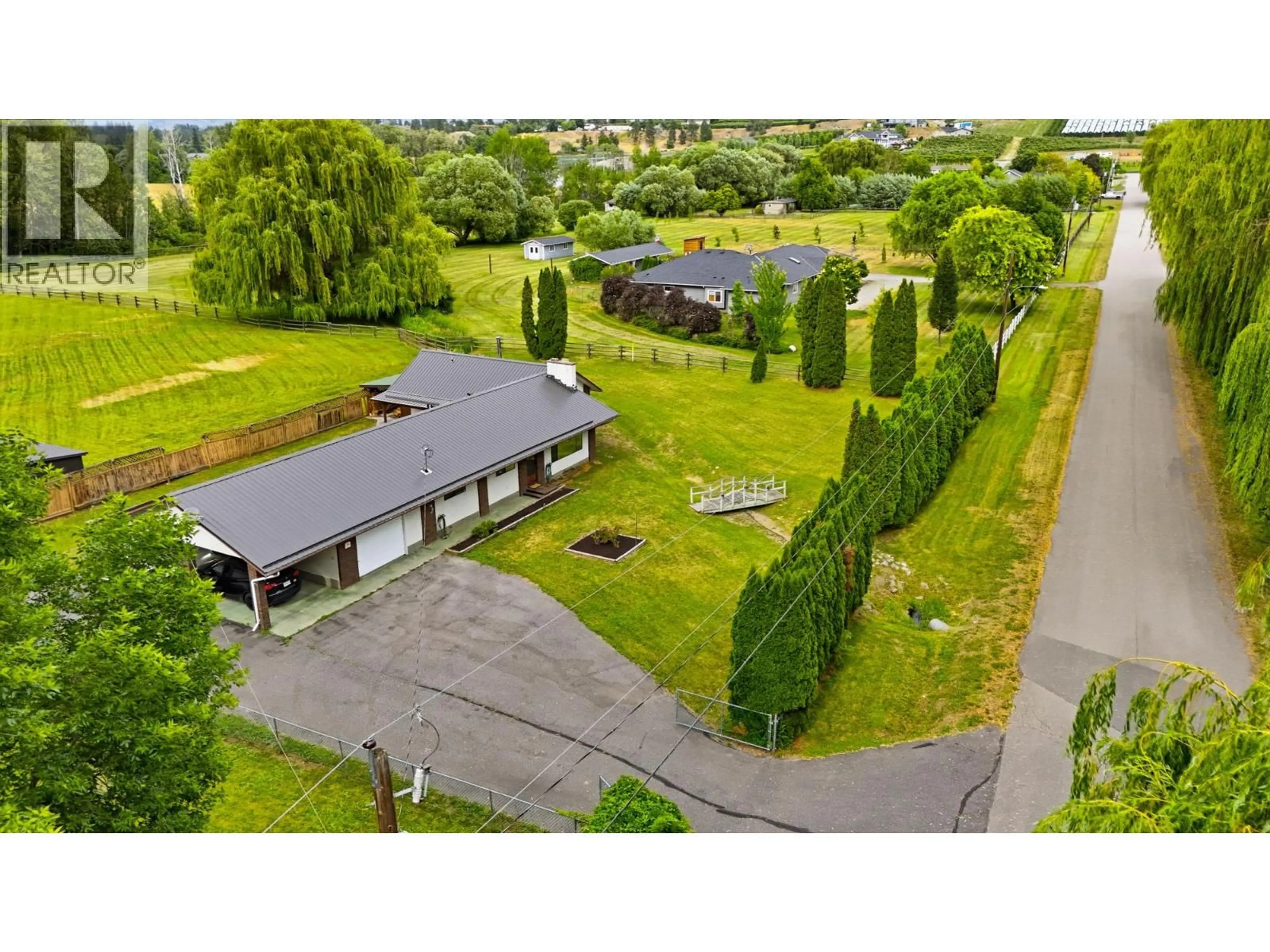 A pic from outside/outdoor area/front of a property/back of a property/a pic from drone, street for 1988 HEIMLICH ROAD, Kelowna British Columbia V1W4A8