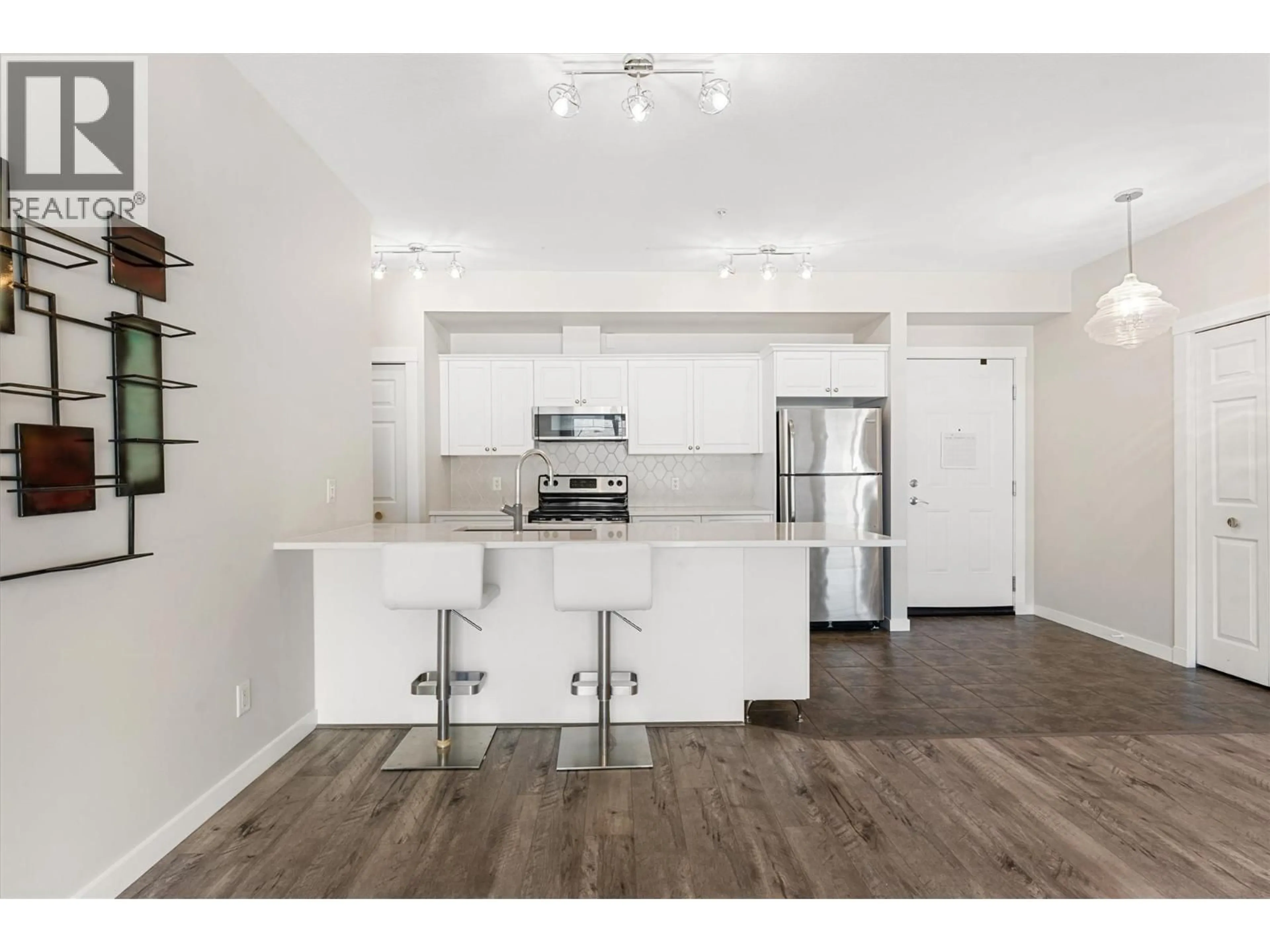 Open concept kitchen, wood/laminate floor for 303 - 3550 WOODSDALE ROAD, Lake Country British Columbia V4V1Y9