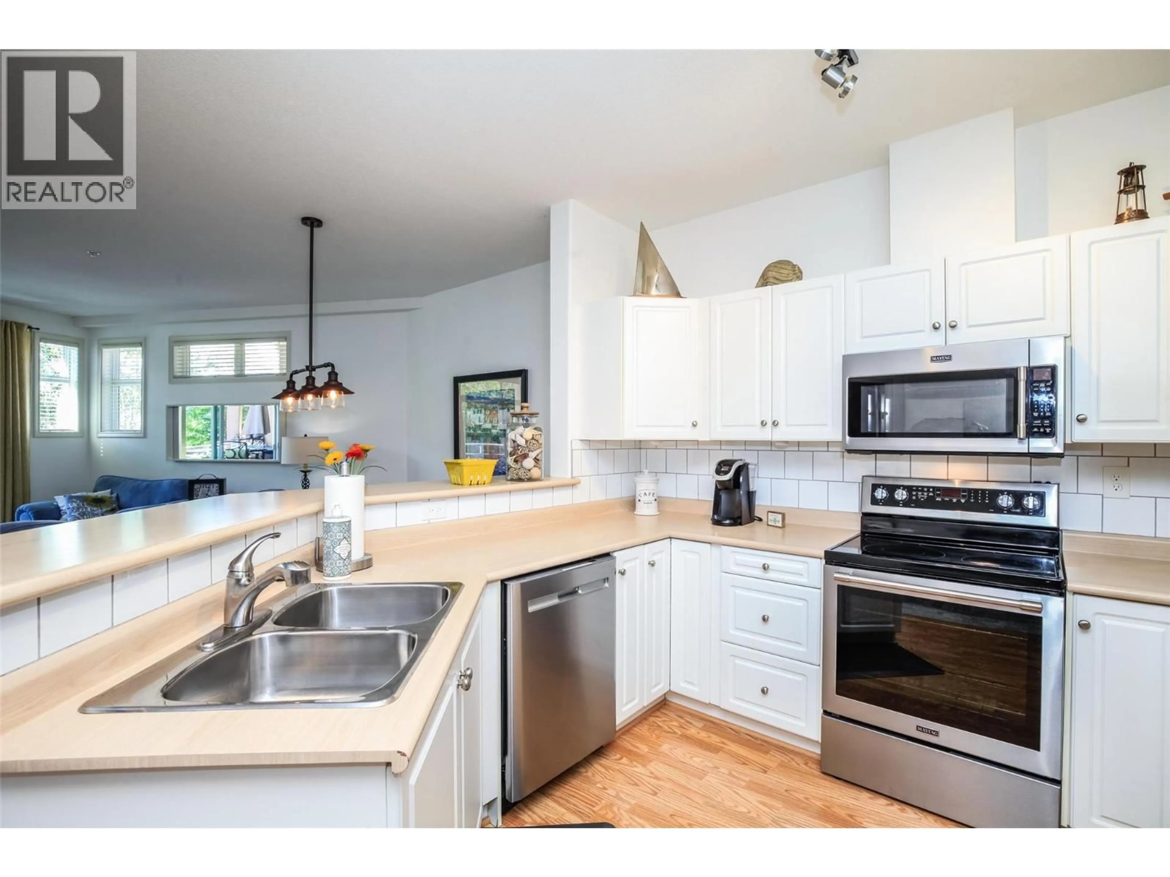 Open concept kitchen, wood/laminate floor for 312 - 1088 SUNSET DRIVE, Kelowna British Columbia V1Y9W1