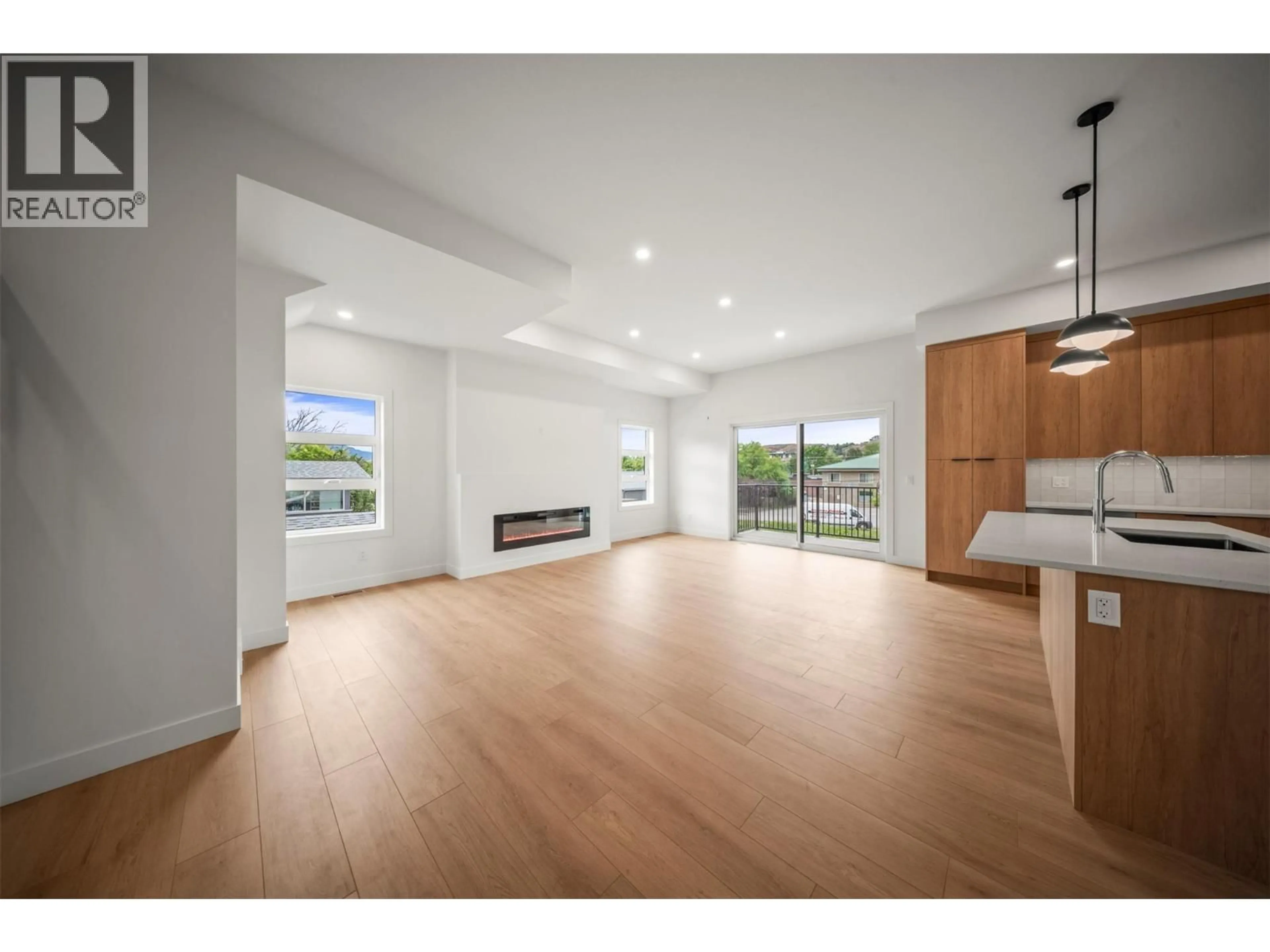 Open concept kitchen, wood/laminate floor for 2 - 4200 30 STREET, Vernon British Columbia V1T5E5