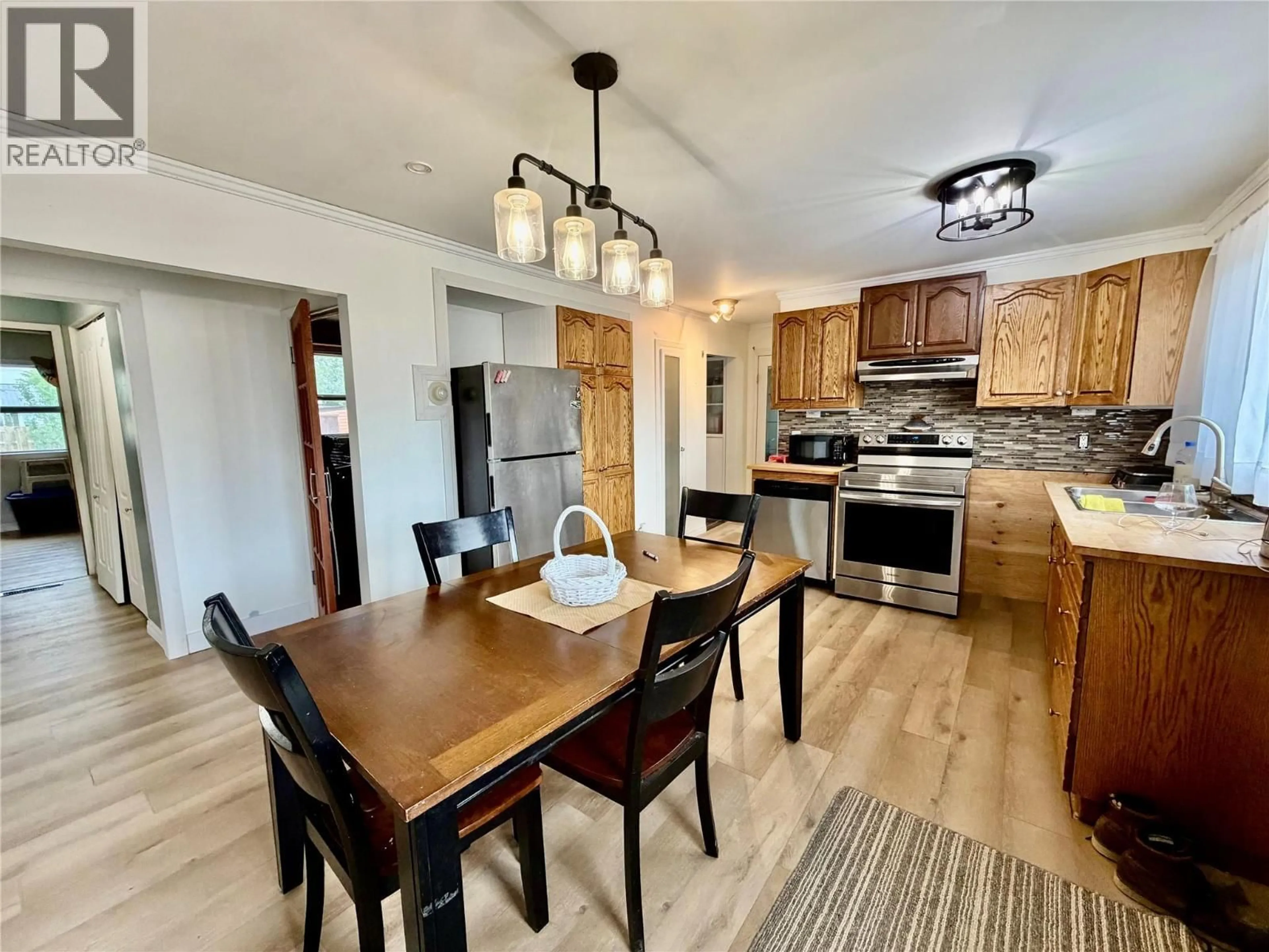 Open concept kitchen, wood/laminate floor for 1604 116 AVENUE, Dawson Creek British Columbia V1G3G4