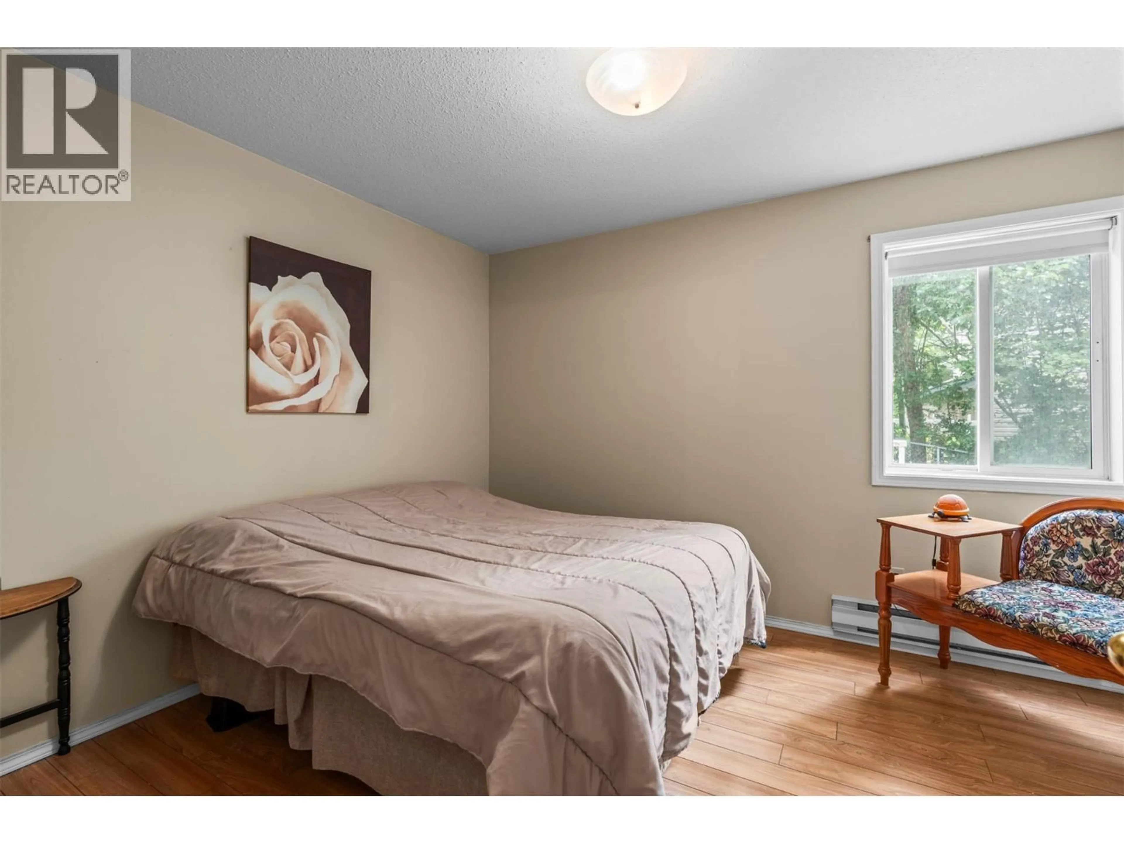 Bedroom with bed, wood/laminate floor for 6 - 4404 PLEASANT VALLEY ROAD, Vernon British Columbia V1T4M3