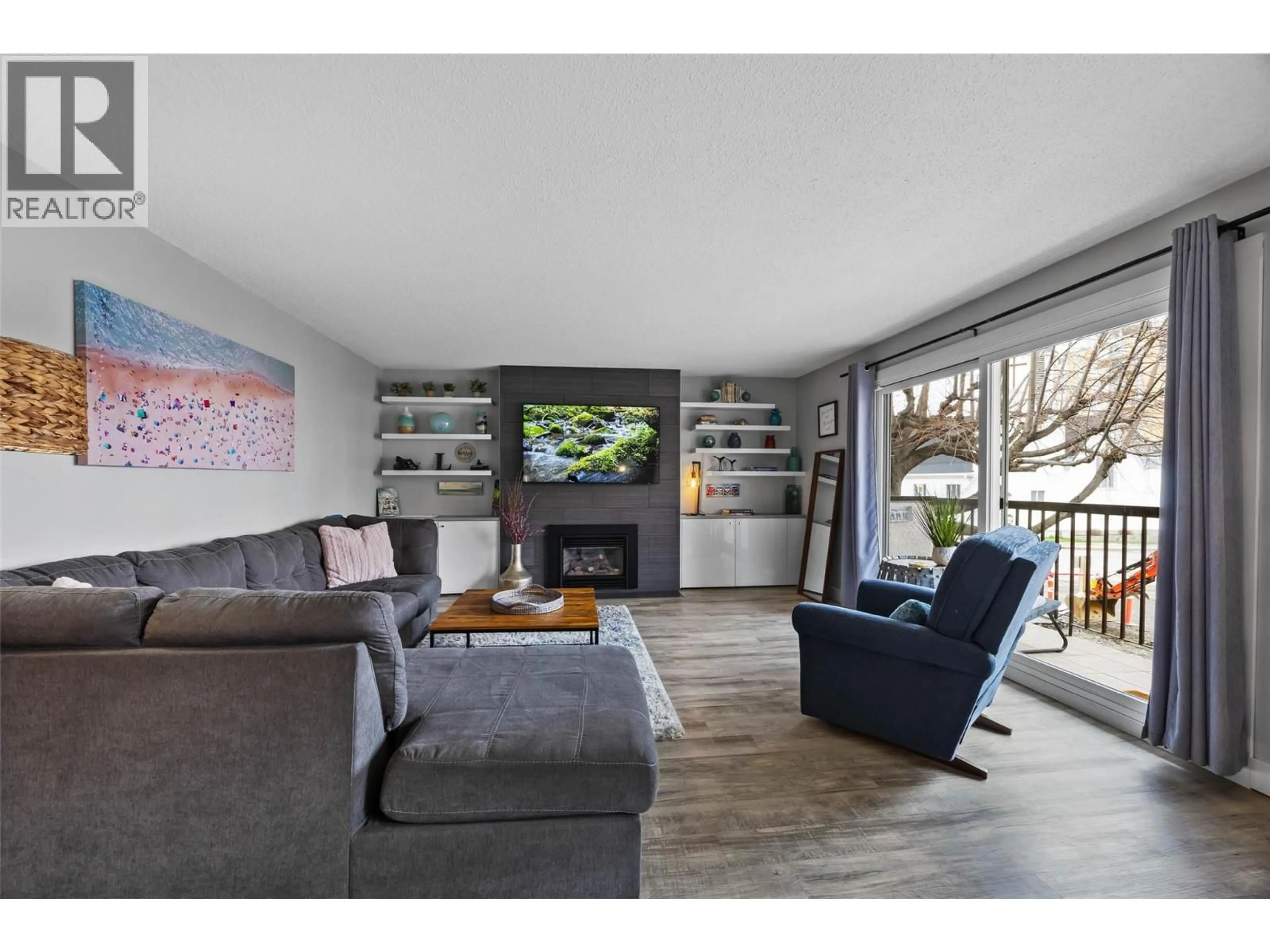 Living room with furniture, wood/laminate floor for 102 - 411 NICOLA STREET, Kamloops British Columbia V2C2P7
