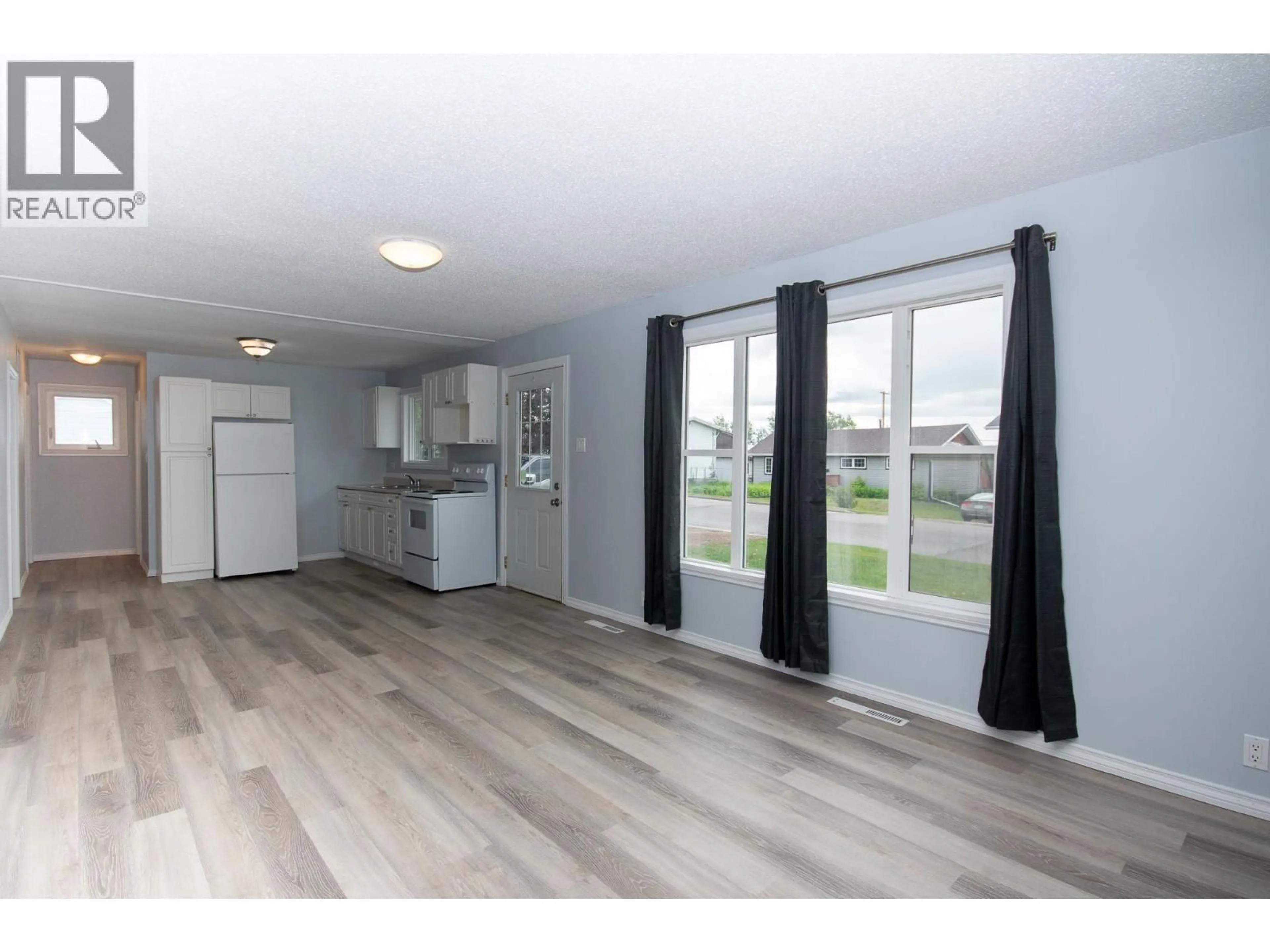 Open concept kitchen, wood/laminate floor for 1140 96A AVENUE, Dawson Creek British Columbia V1G1M8