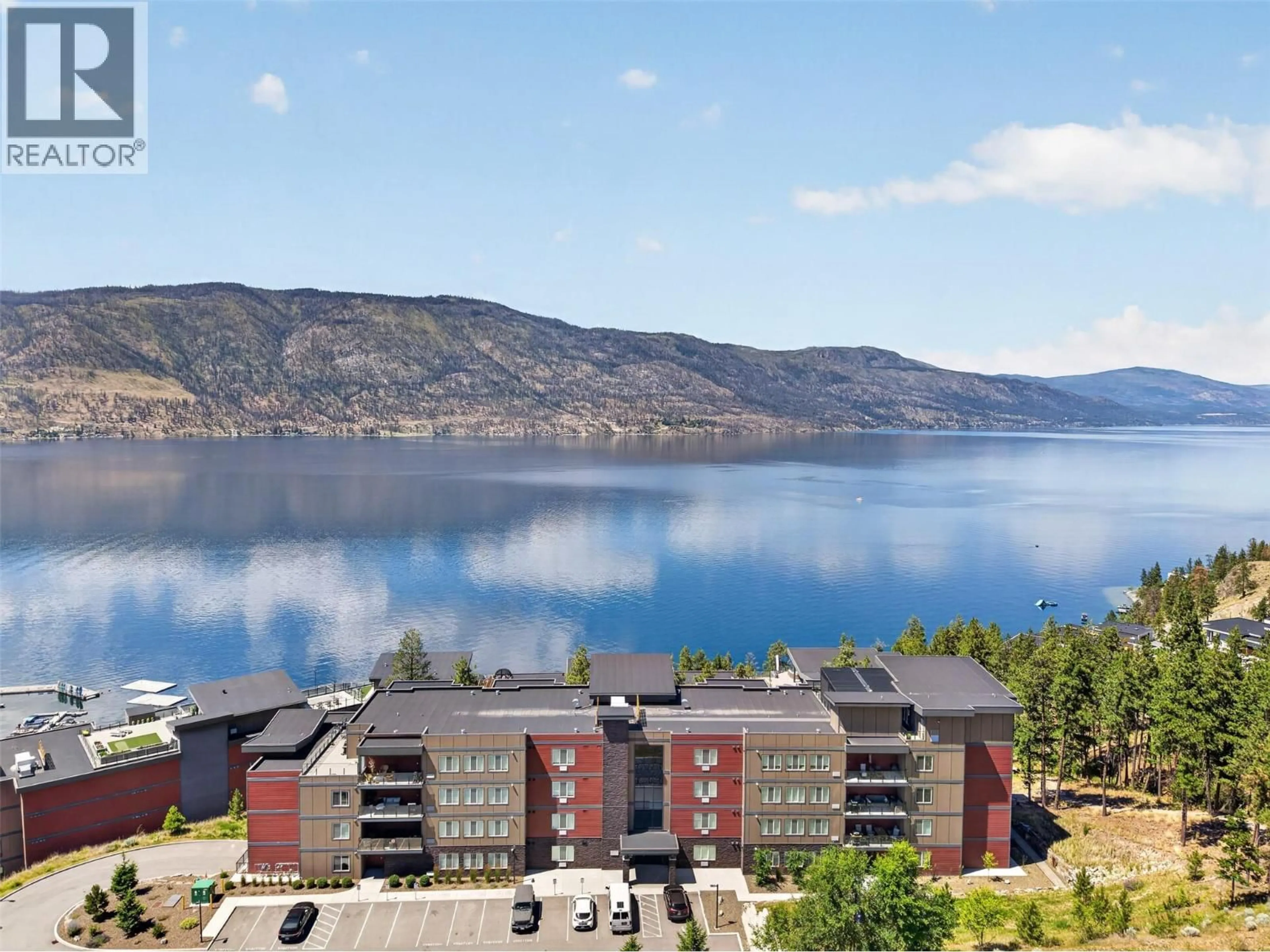 A pic from outside/outdoor area/front of a property/back of a property/a pic from drone, water/lake/river/ocean view for 101 - 3434 MCKINLEY BEACH DRIVE, Kelowna British Columbia V1V0H3