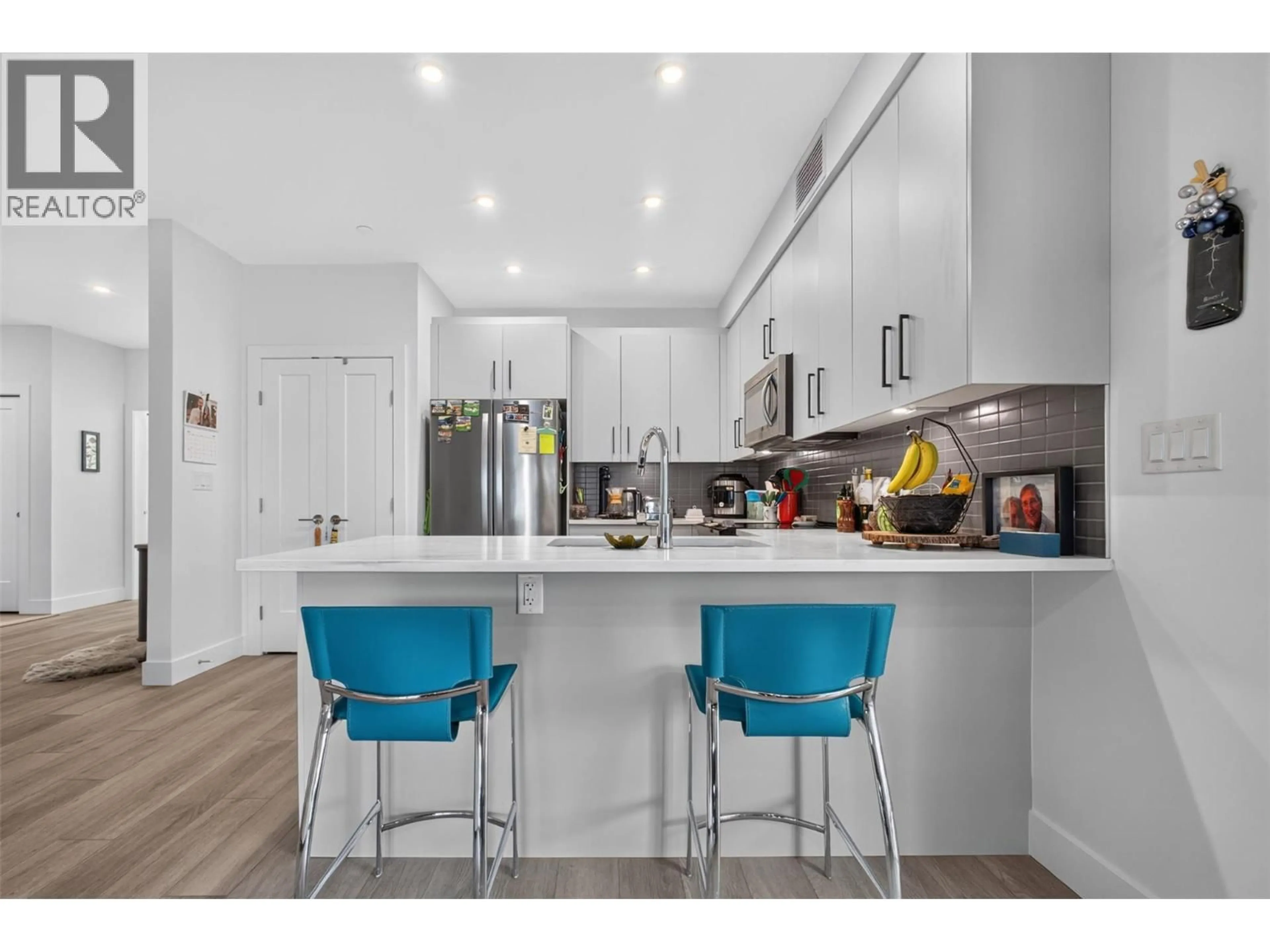 Open concept kitchen, wood/laminate floor for 101 - 3434 MCKINLEY BEACH DRIVE, Kelowna British Columbia V1V0H3