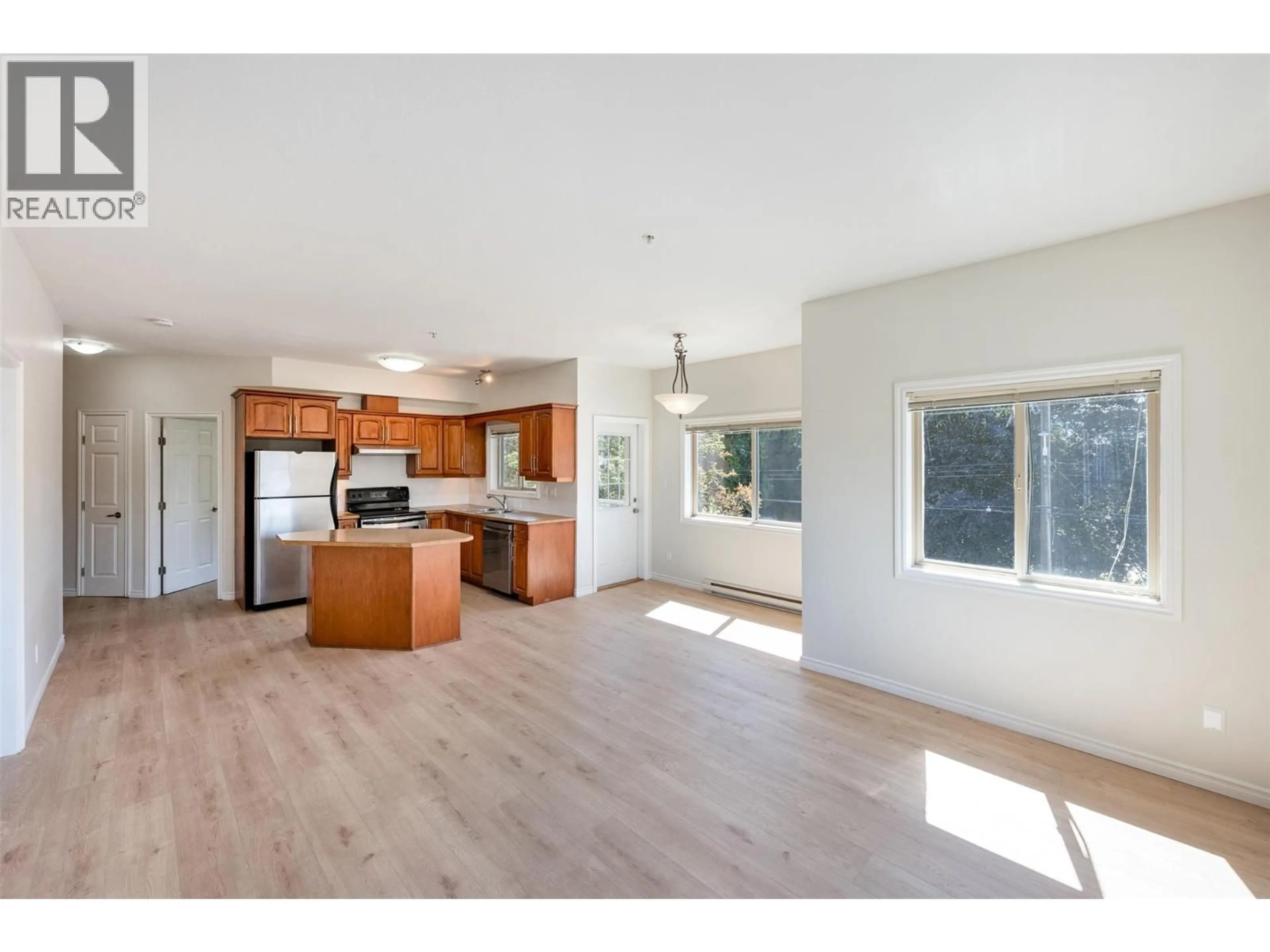 Open concept kitchen, wood/laminate floor for 301 - 196 WADE AVENUE WEST, Penticton British Columbia V2A1T6