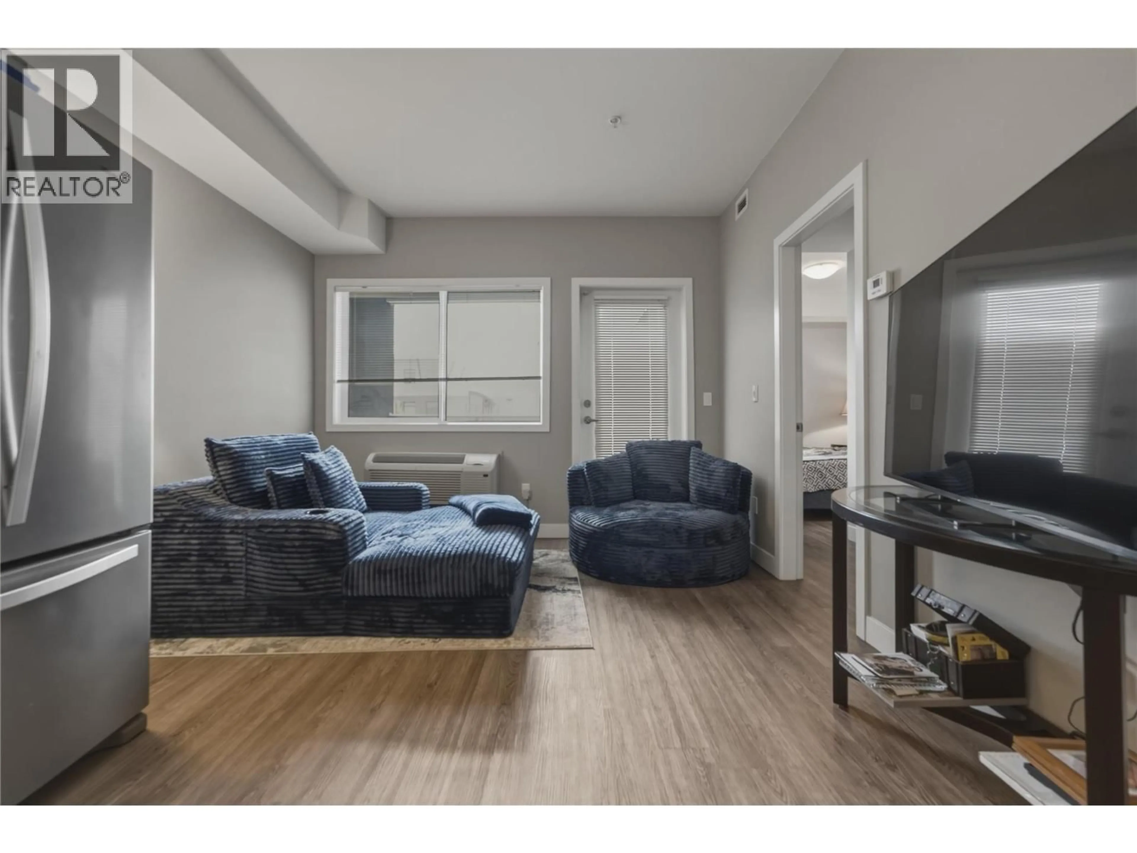 Living room with furniture, wood/laminate floor for 209 - 3409 28 AVENUE, Vernon British Columbia V1T8J6