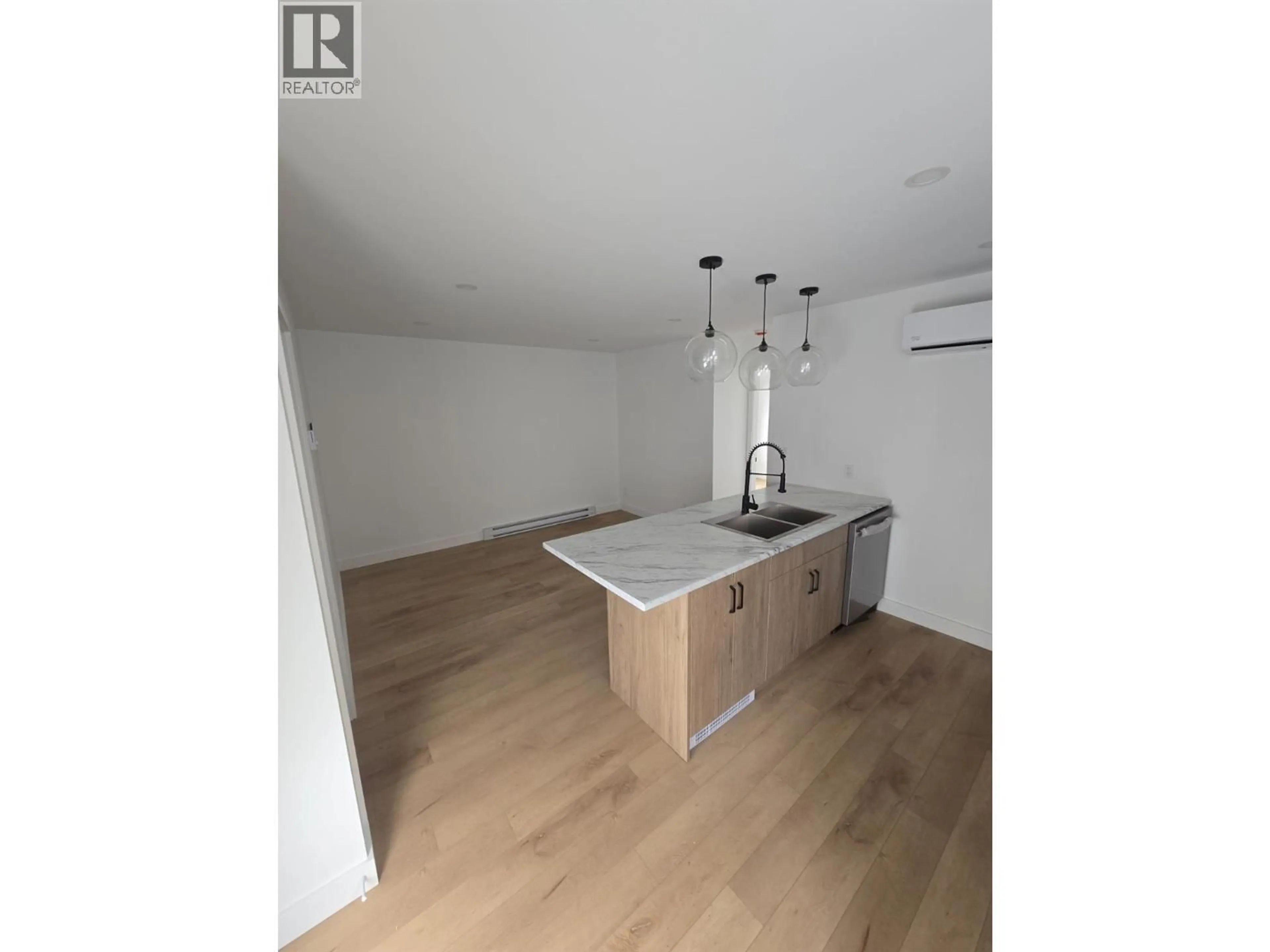 Open concept kitchen, wood/laminate floor for 1315/1317 THIRD STREET WEST, Revelstoke British Columbia V0E2S0