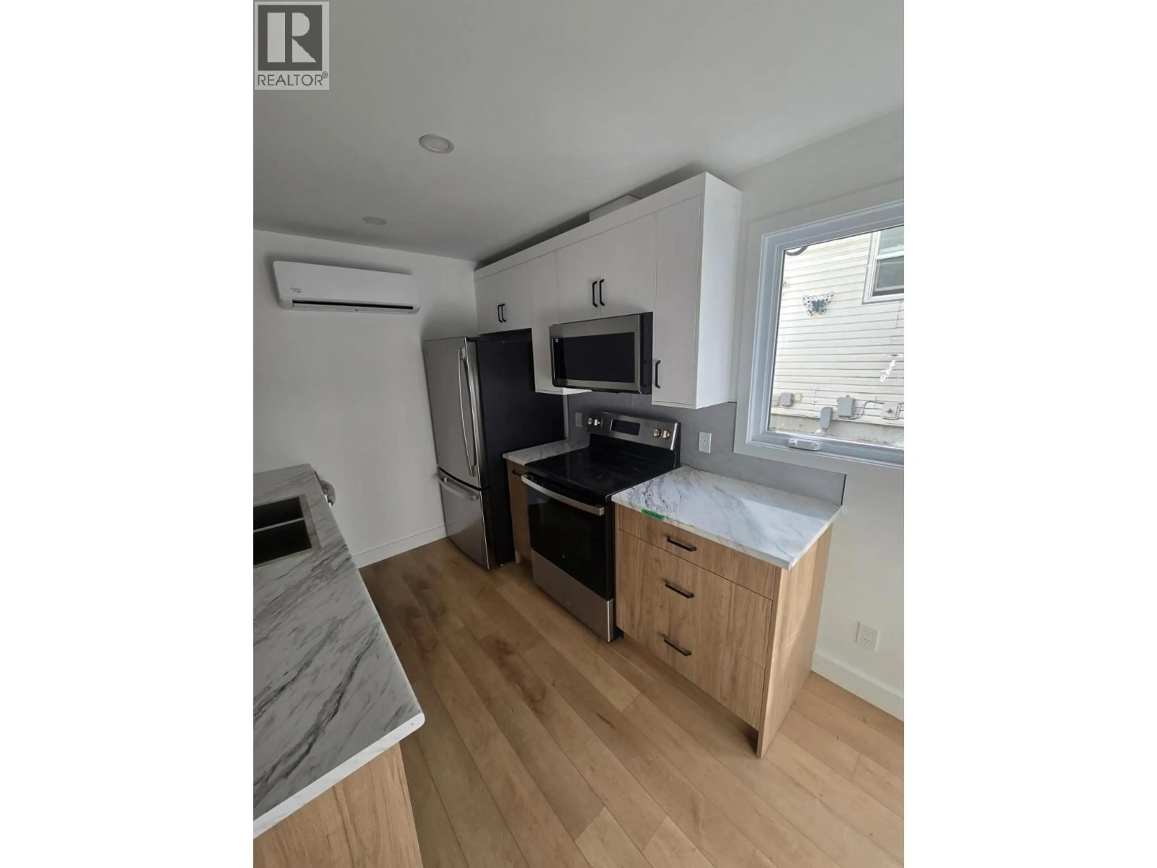 Open concept kitchen, wood/laminate floor for 1315/1317 THIRD STREET WEST, Revelstoke British Columbia V0E2S0