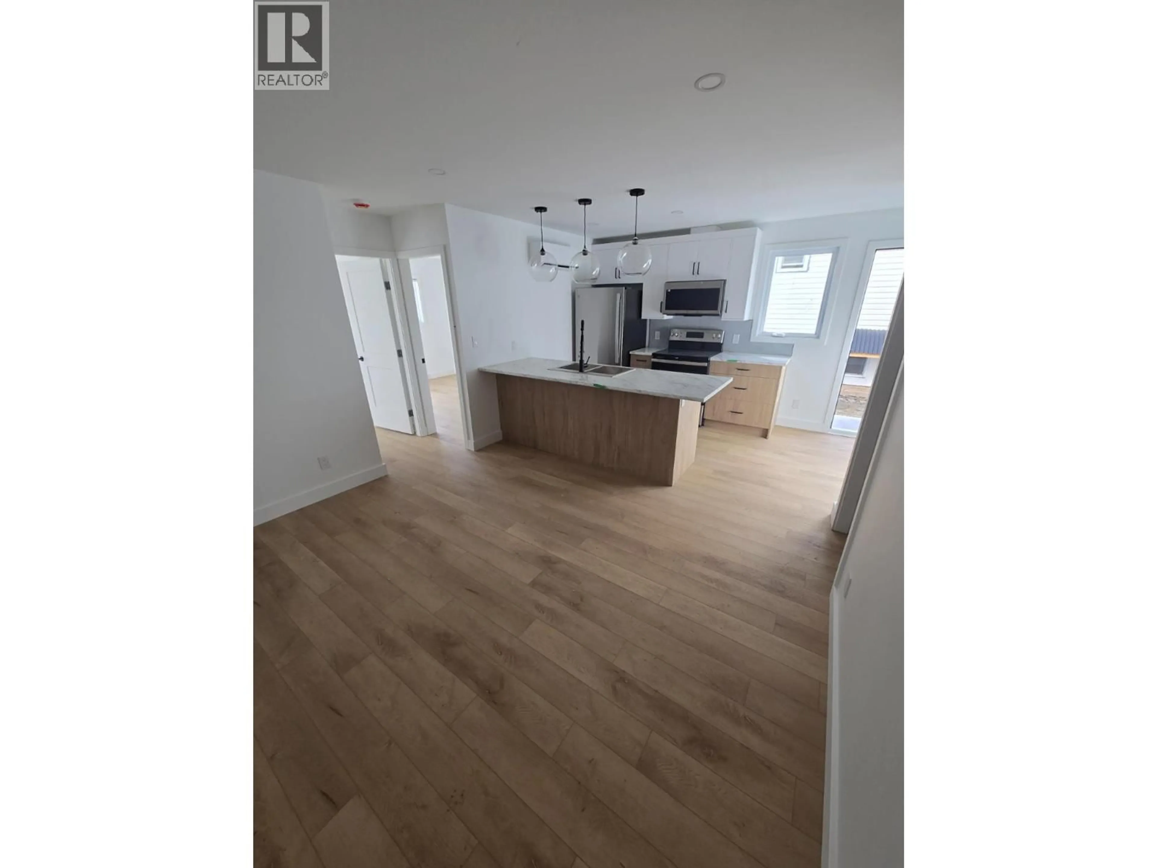 Open concept kitchen, wood/laminate floor for 1315/1317 THIRD STREET WEST, Revelstoke British Columbia V0E2S0