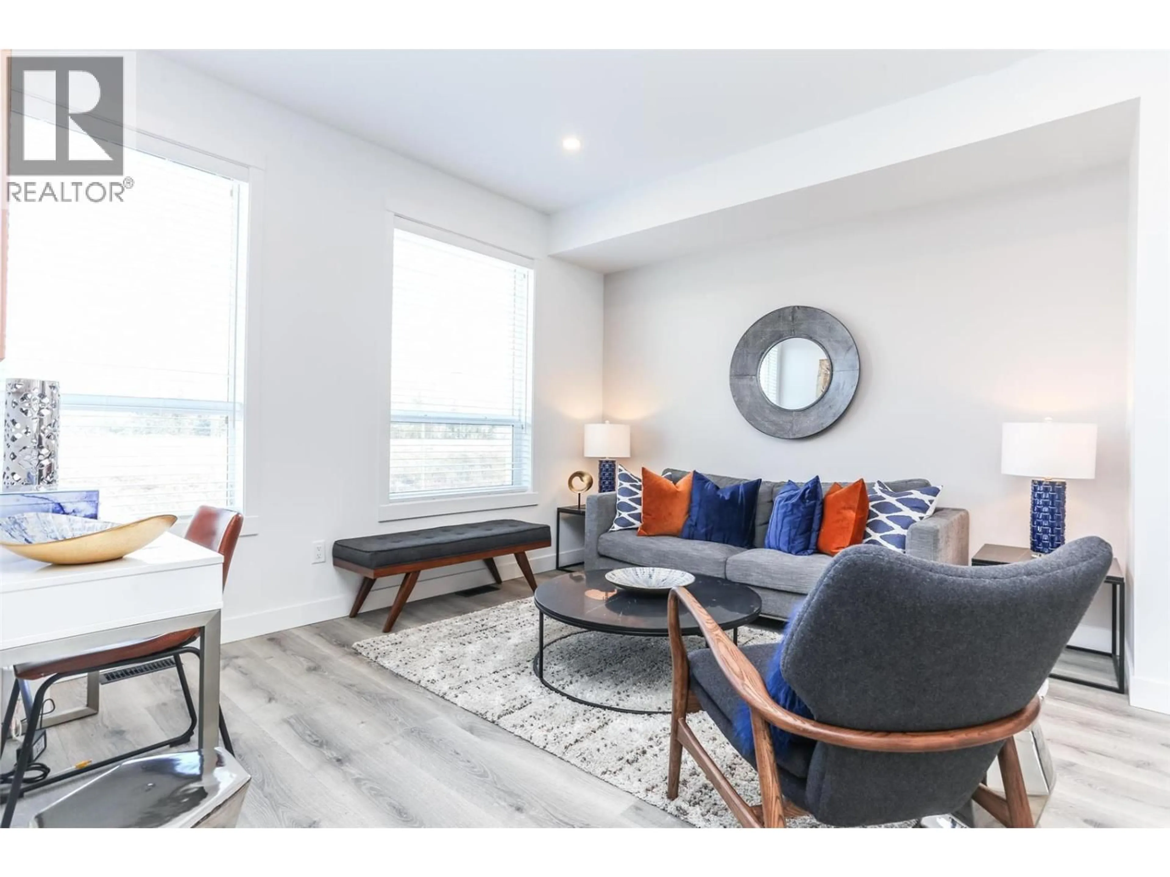 Living room with furniture, wood/laminate floor for 109 - 610 ACADEMY WAY, Kelowna British Columbia V1V0H2