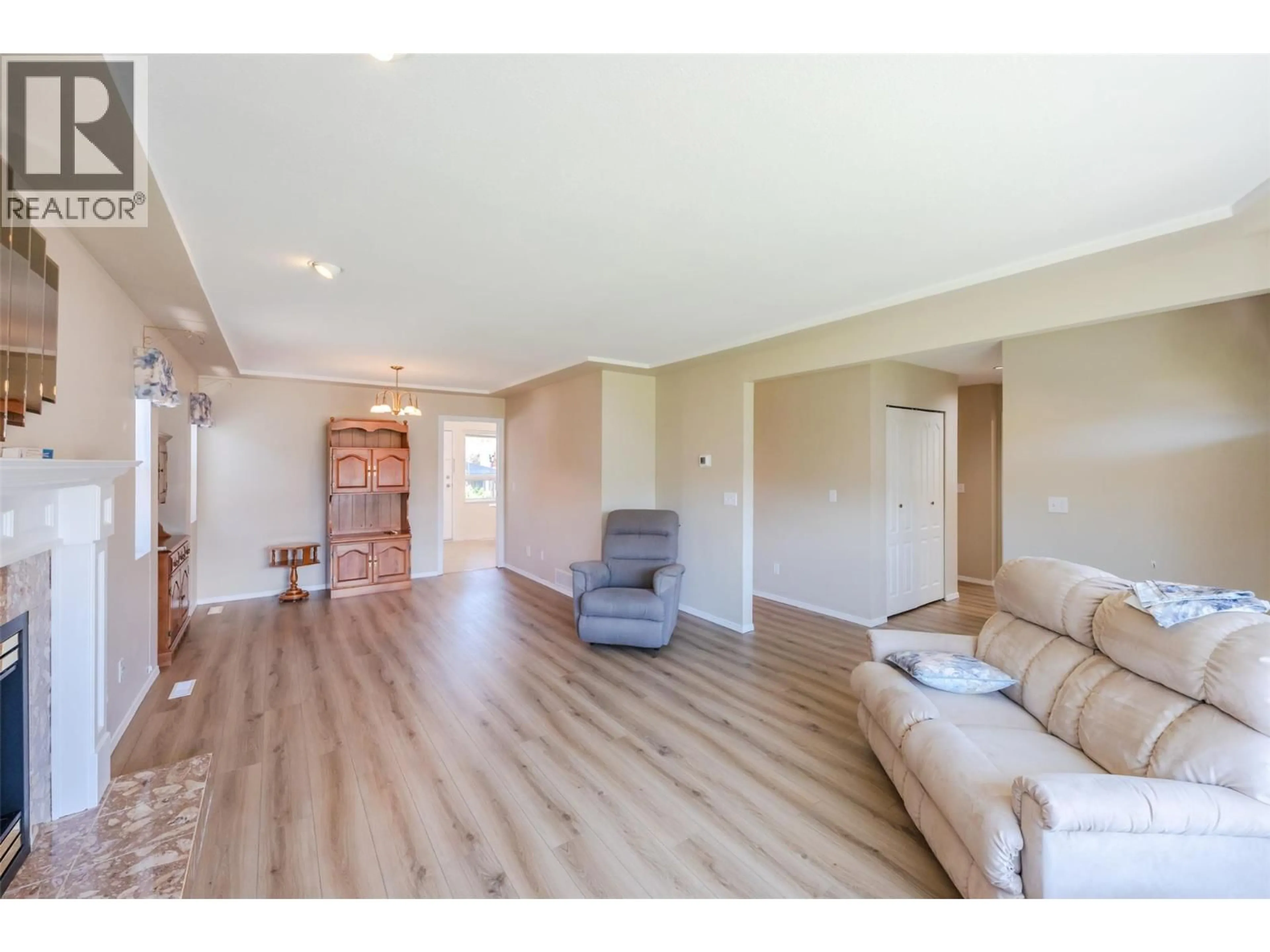 Living room with furniture, wood/laminate floor for 167 WYLES CRESCENT, Penticton British Columbia V2A8M3