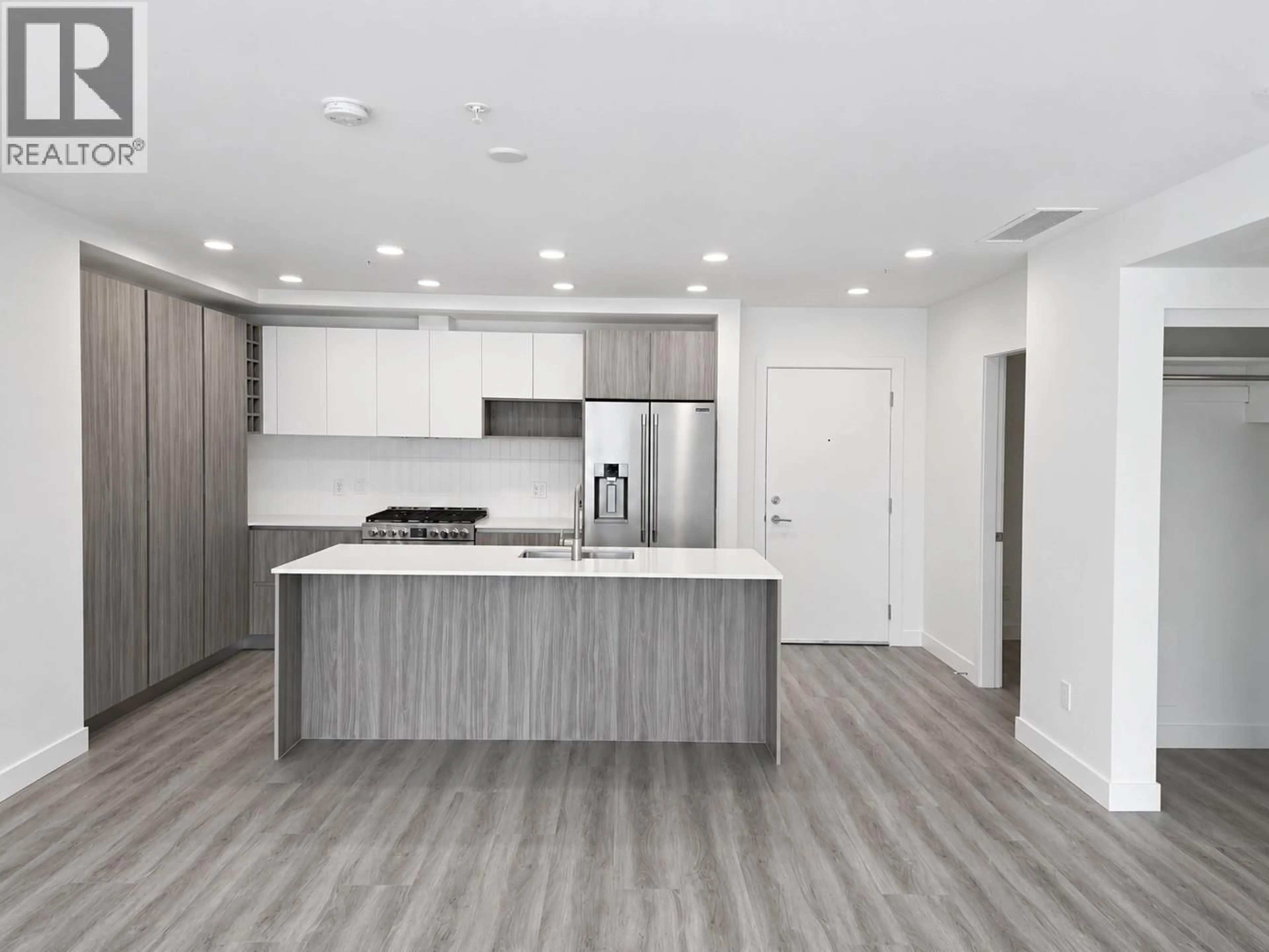 Open concept kitchen, wood/laminate floor for 204 - 2780 OLALLA ROAD, West Kelowna British Columbia V1Z2A9